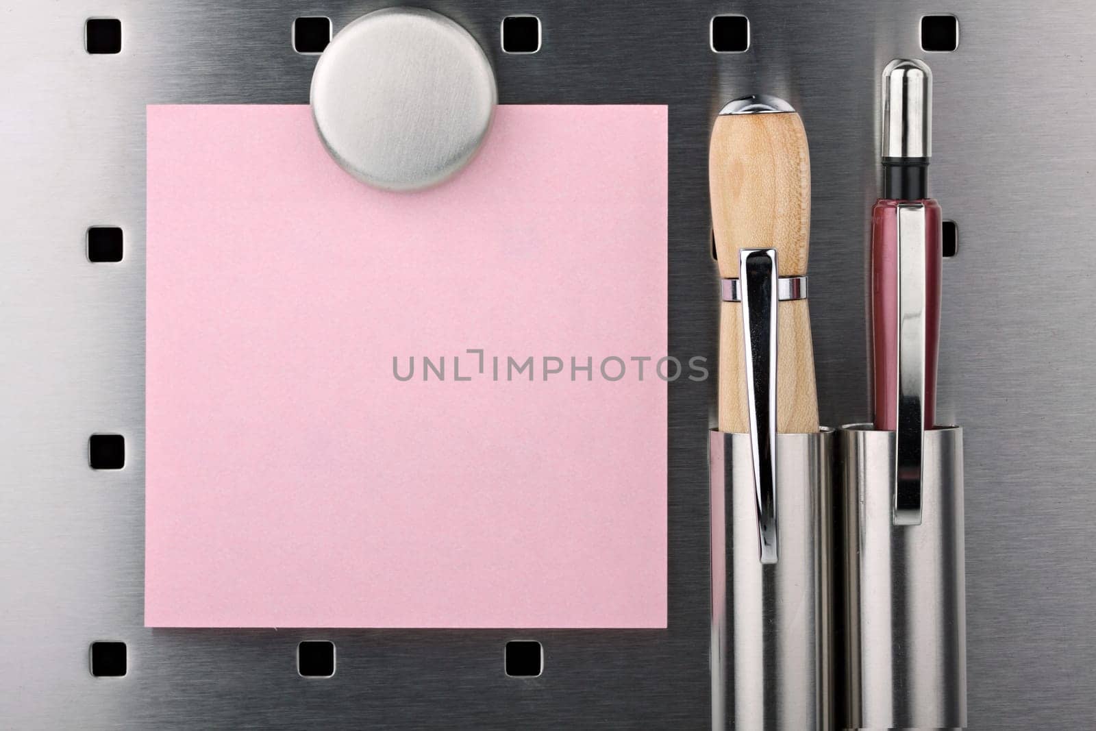 Sticky notes,pencil and pen with magnet on pin board.