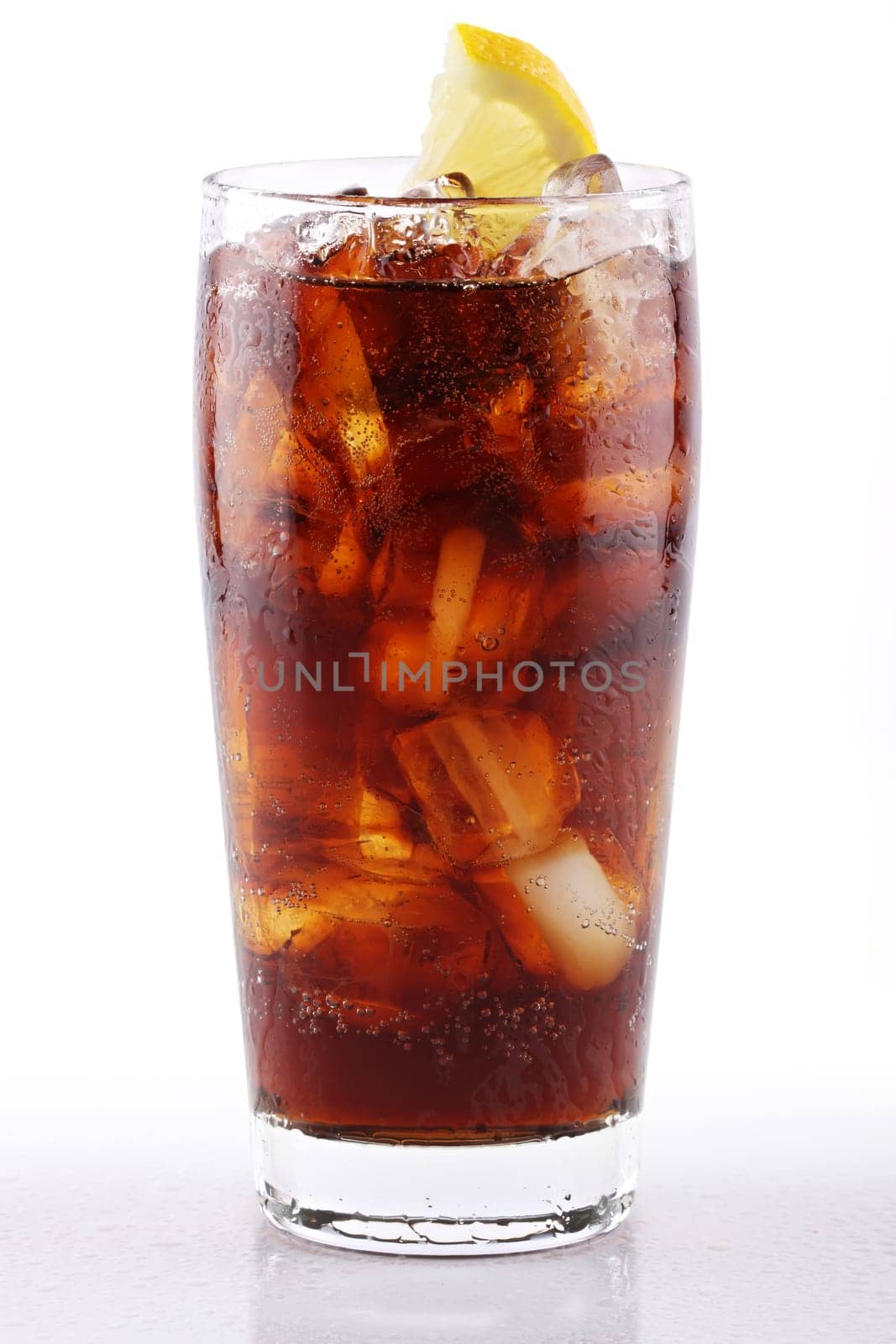 Ice-cold cola with ice and lemon.