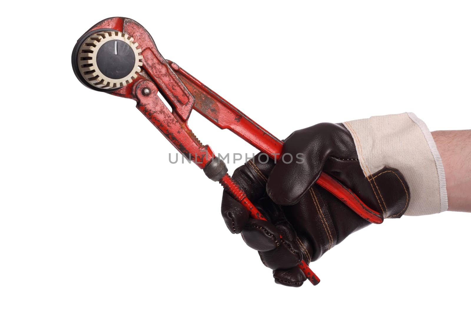 Hand with working shoe and pipe wrench on heating knob