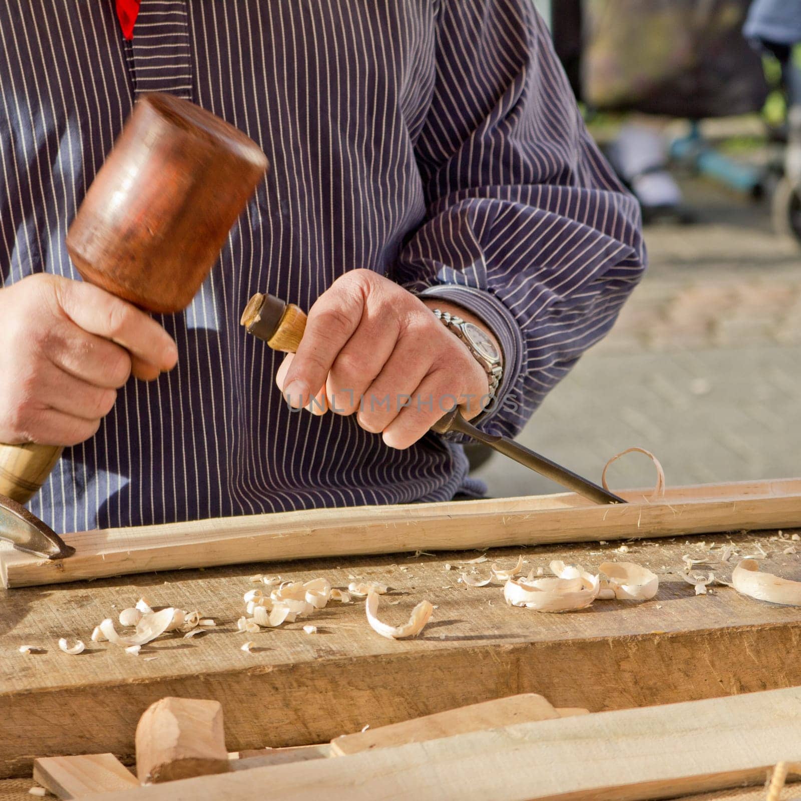 The woodcarver work in the workshop. Work of artist.