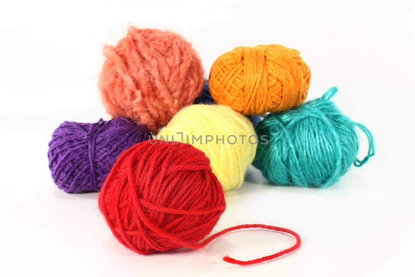 Colorful ball of wool against white background