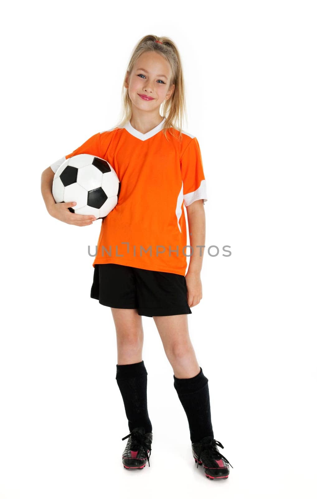 Nine year old girl holding soccer ball isolated on white.