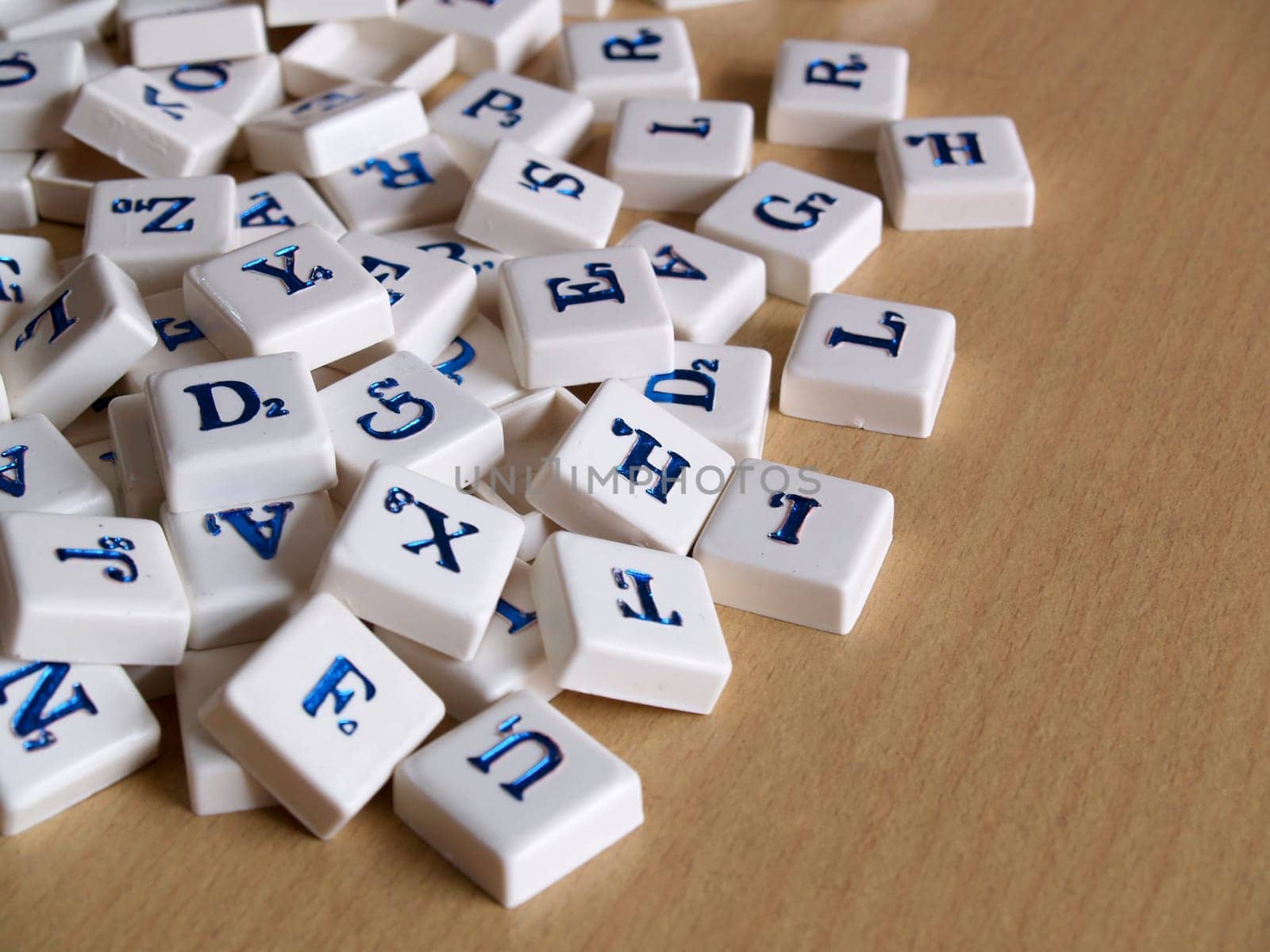 Scrabble pieces over wood background