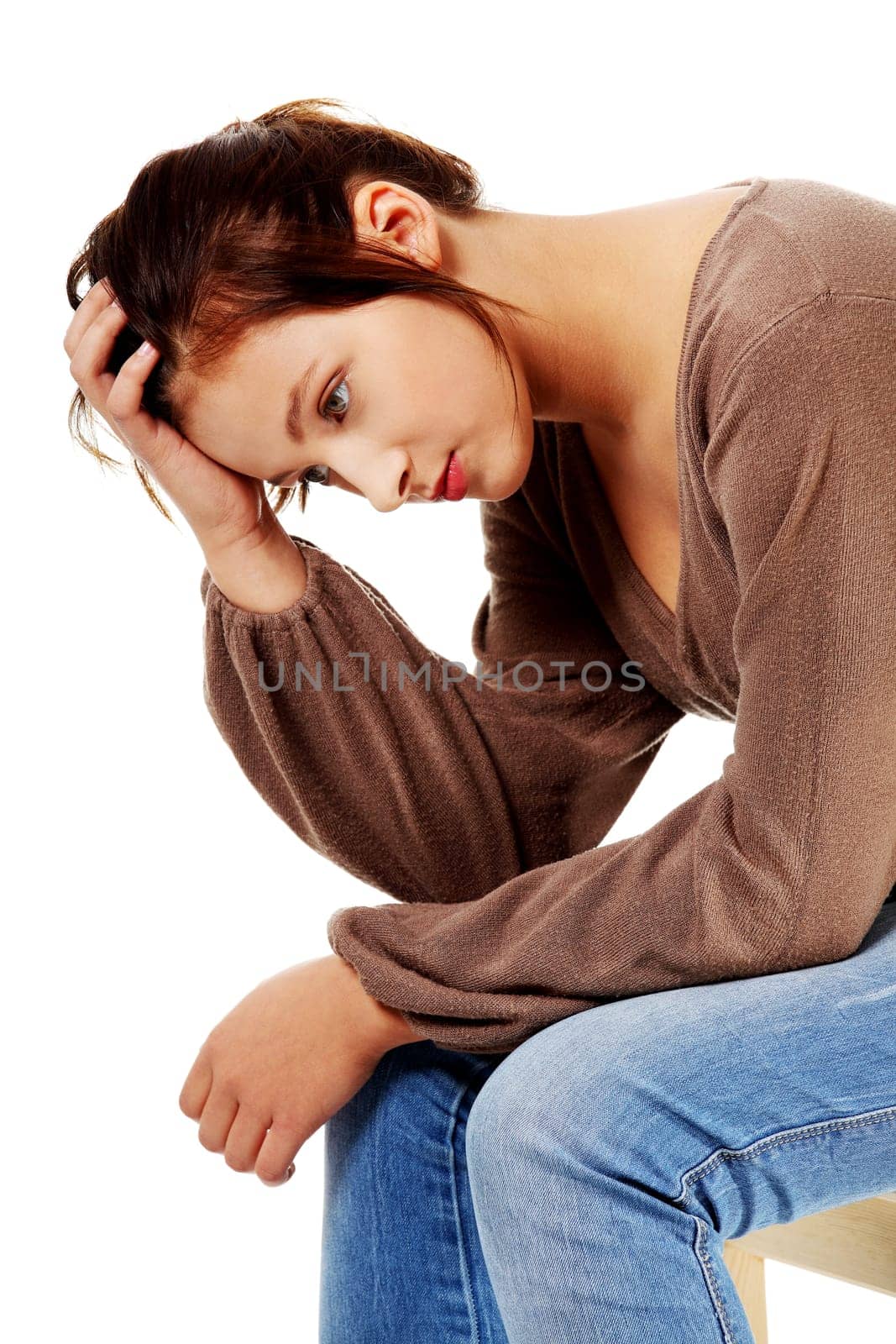 Sad caucasian pretty girl thinking and touching her head.