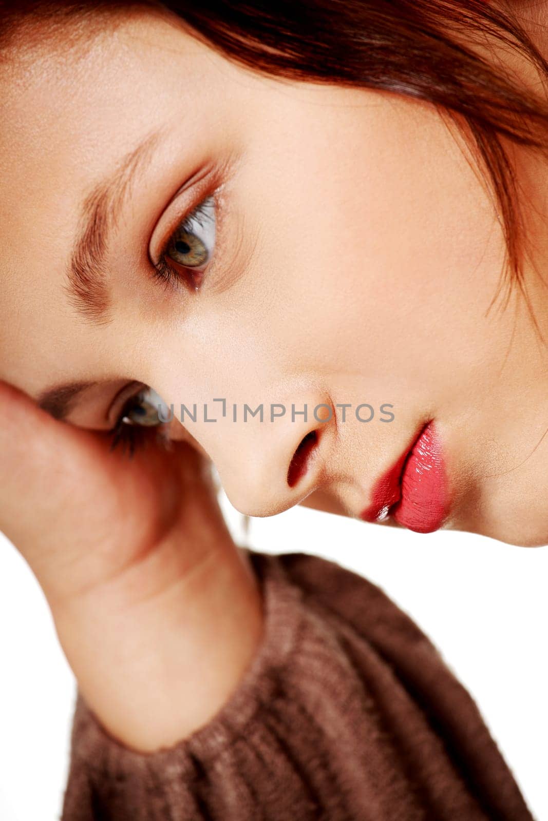 Closeup portrait of thinking caucasian woman over white background.