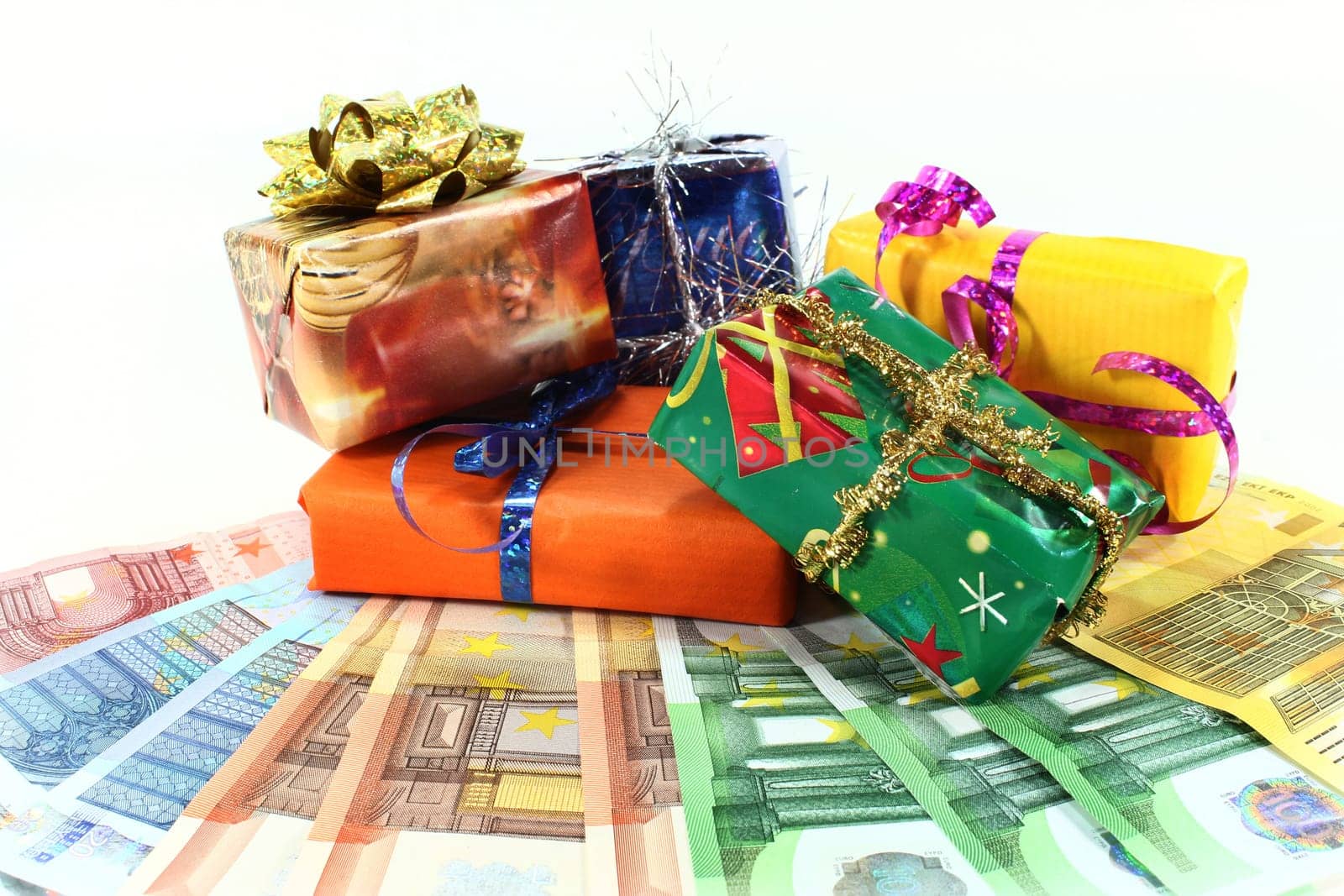 Christmas gifts and euro bills against white background
