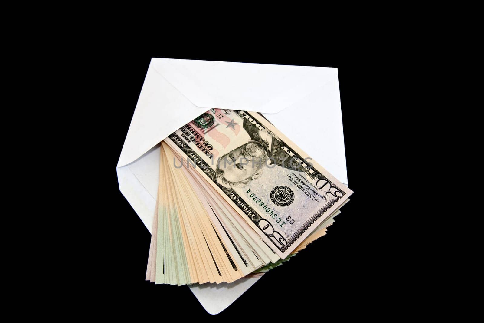 Dollar bills in a brif envelope on black background
