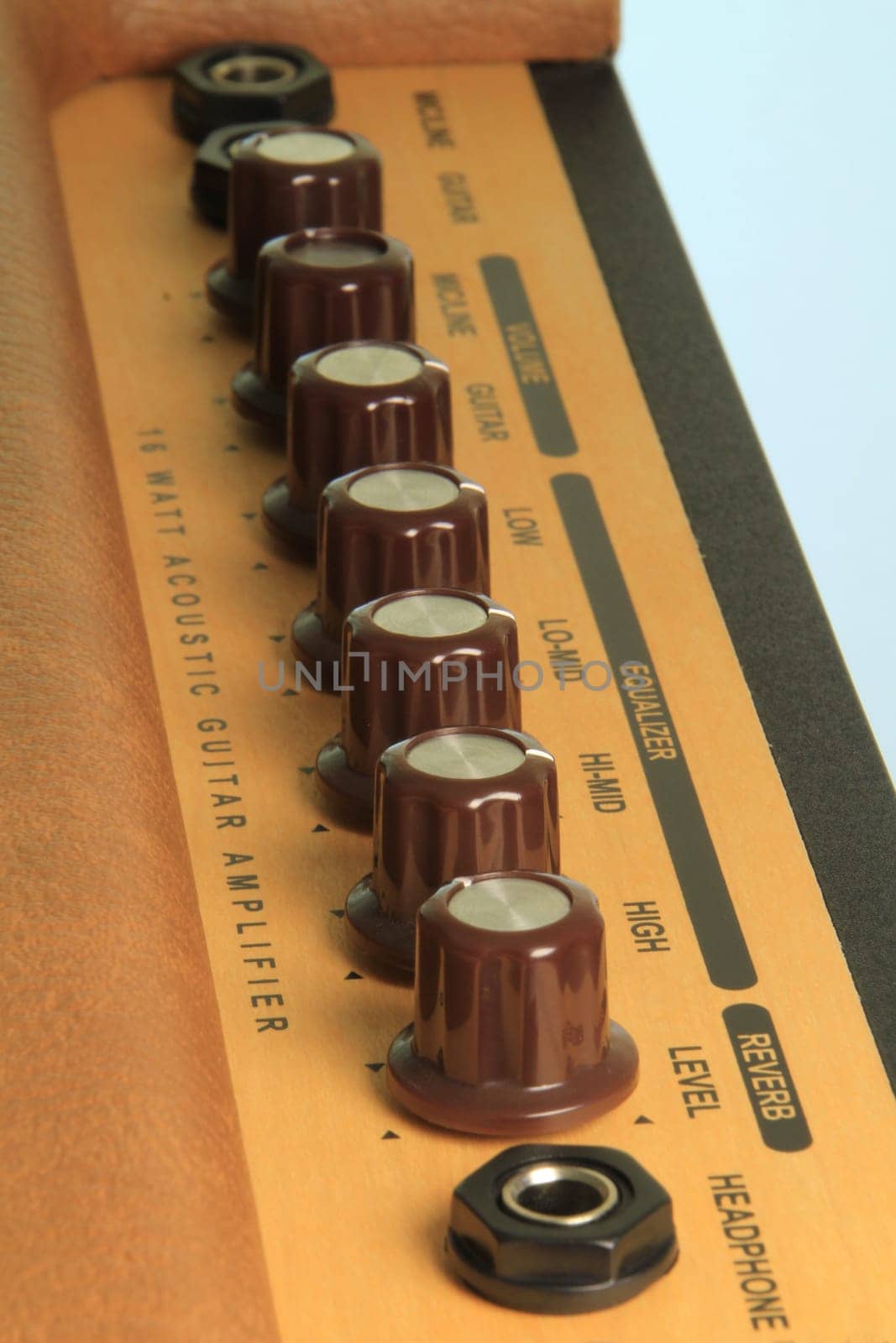 An angled view of the dials on a guitar amplifier