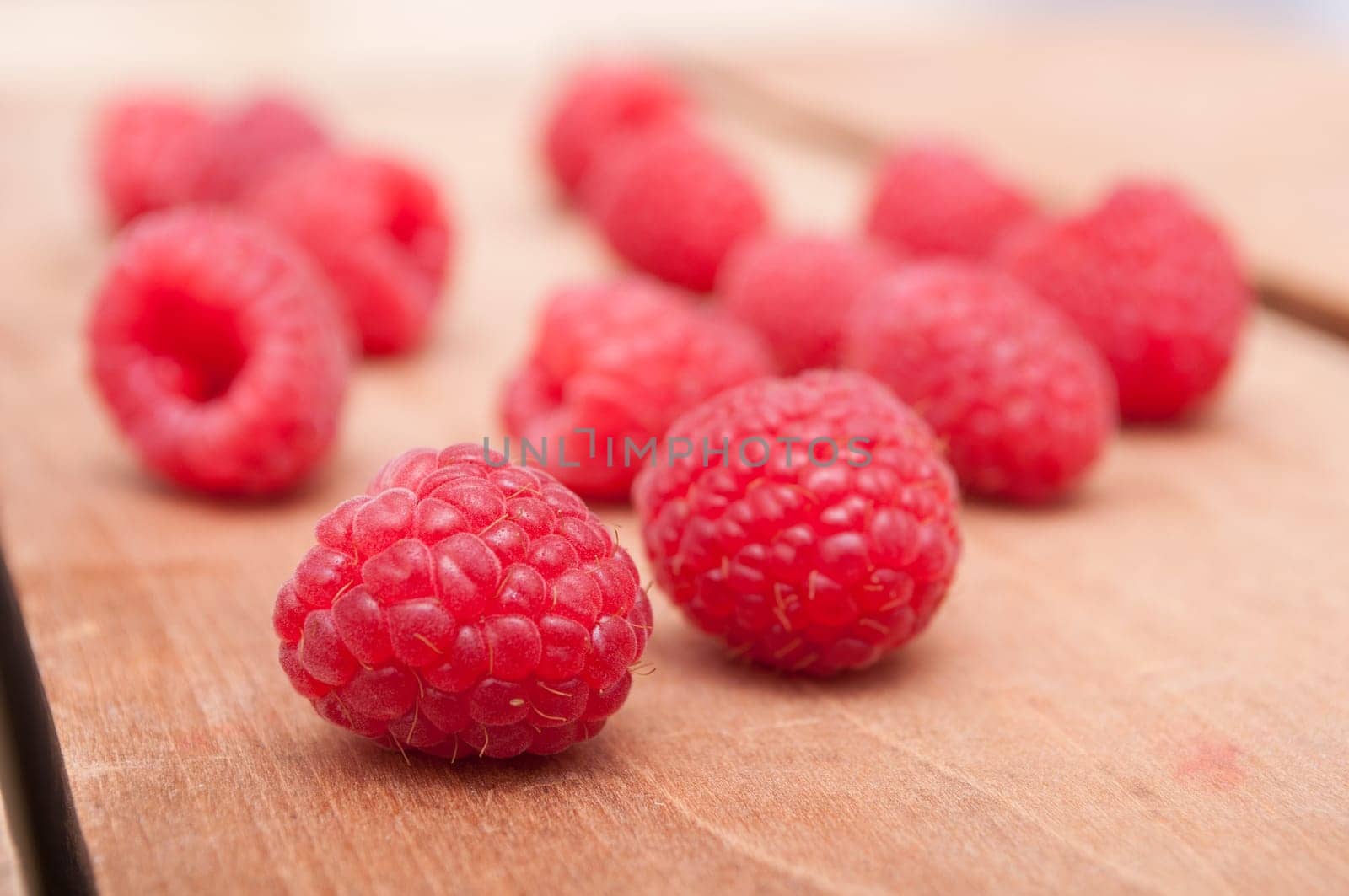 Fresh Red Raspberries on Old Wooden Table