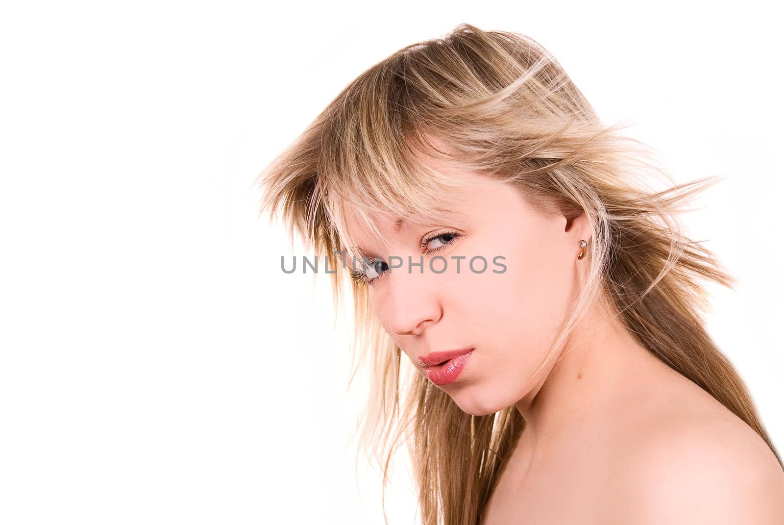 Beautiful blond lovely girl with tousled hair on white