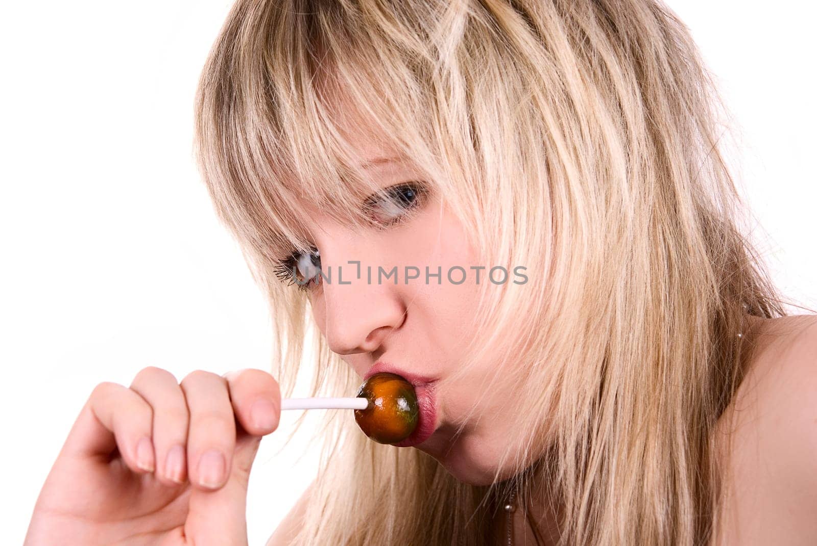 Beautiful girl sucking lollipop on white