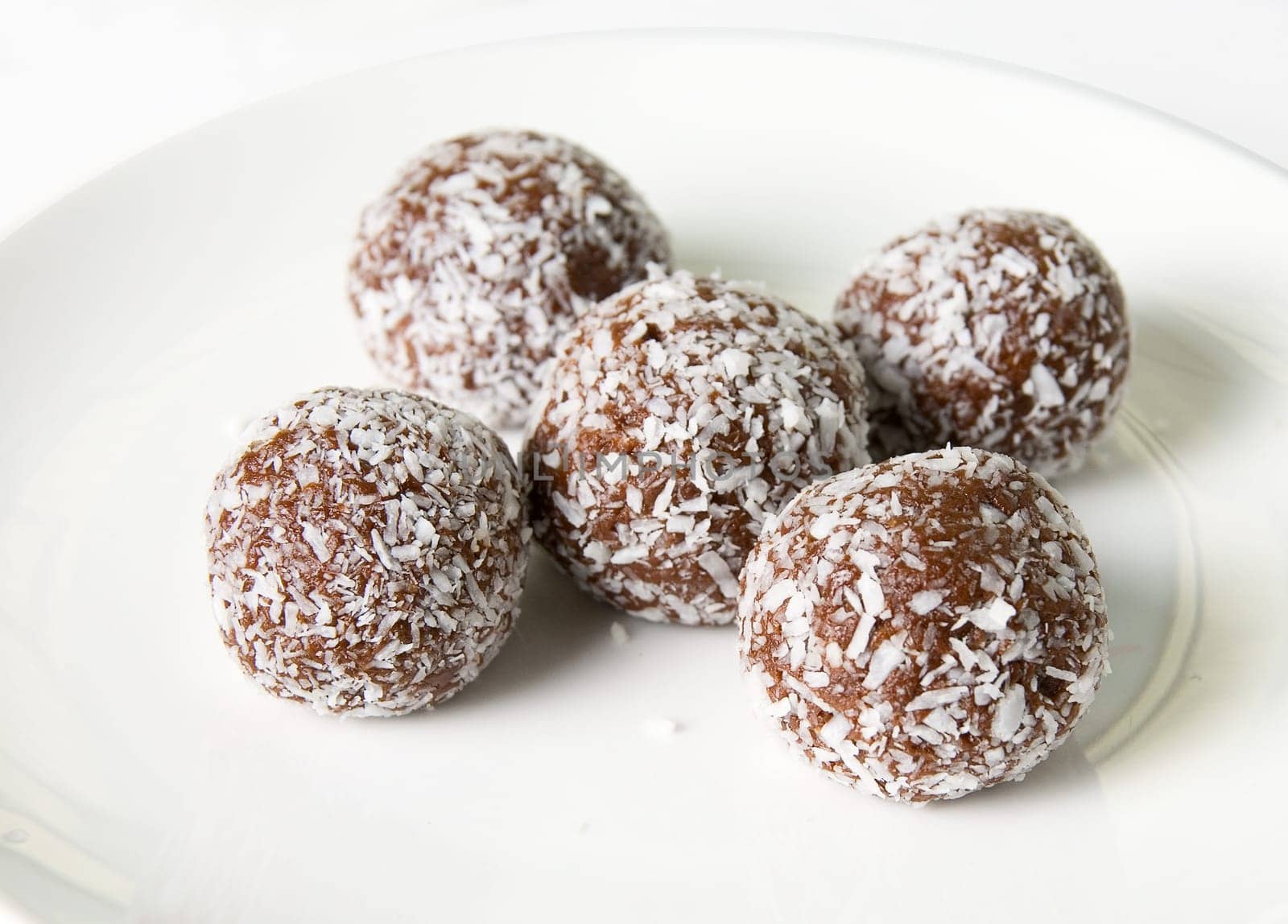 Chocolate ball at plate isolated on white background