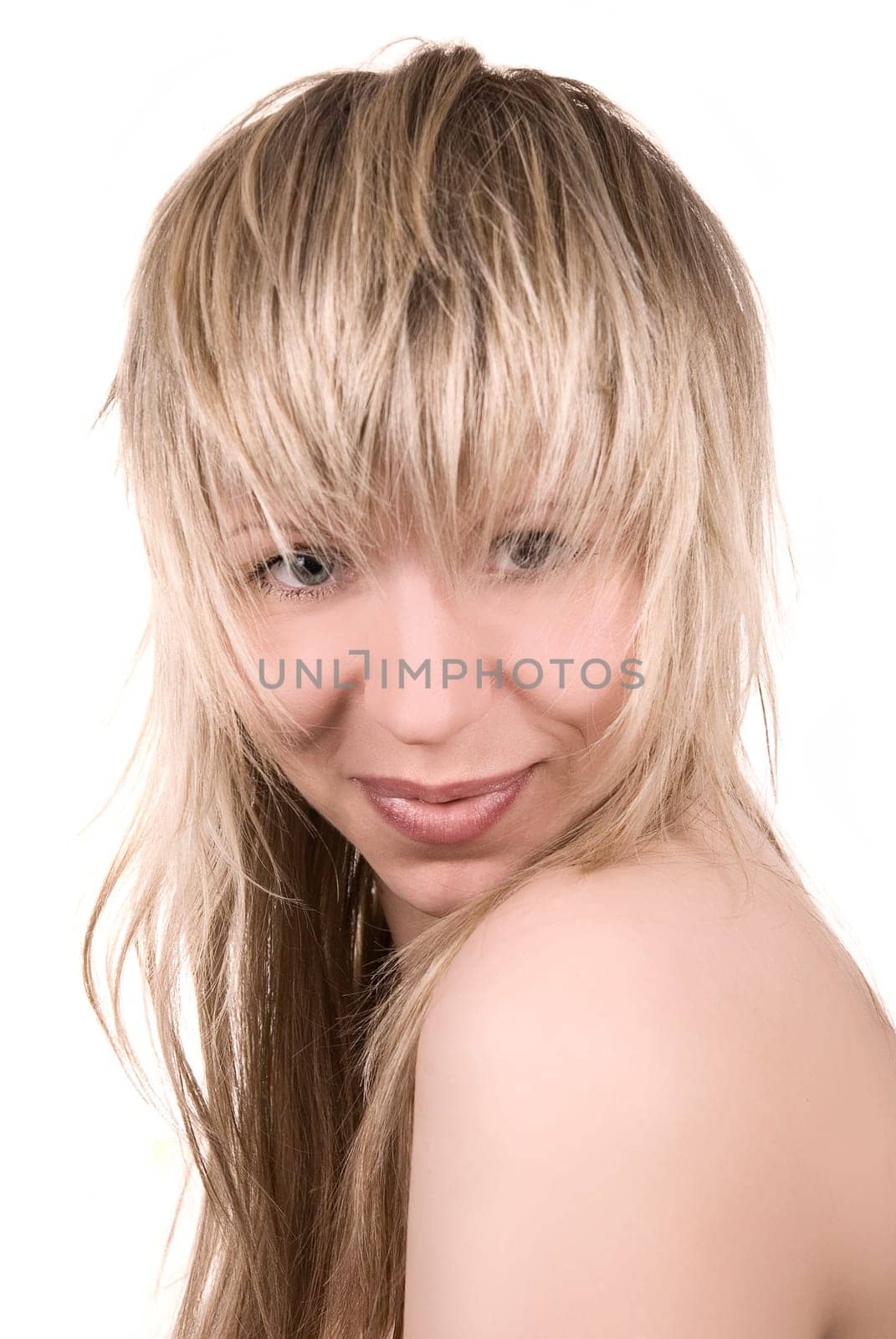 Beautiful blond sexy girl with tousled hair on white