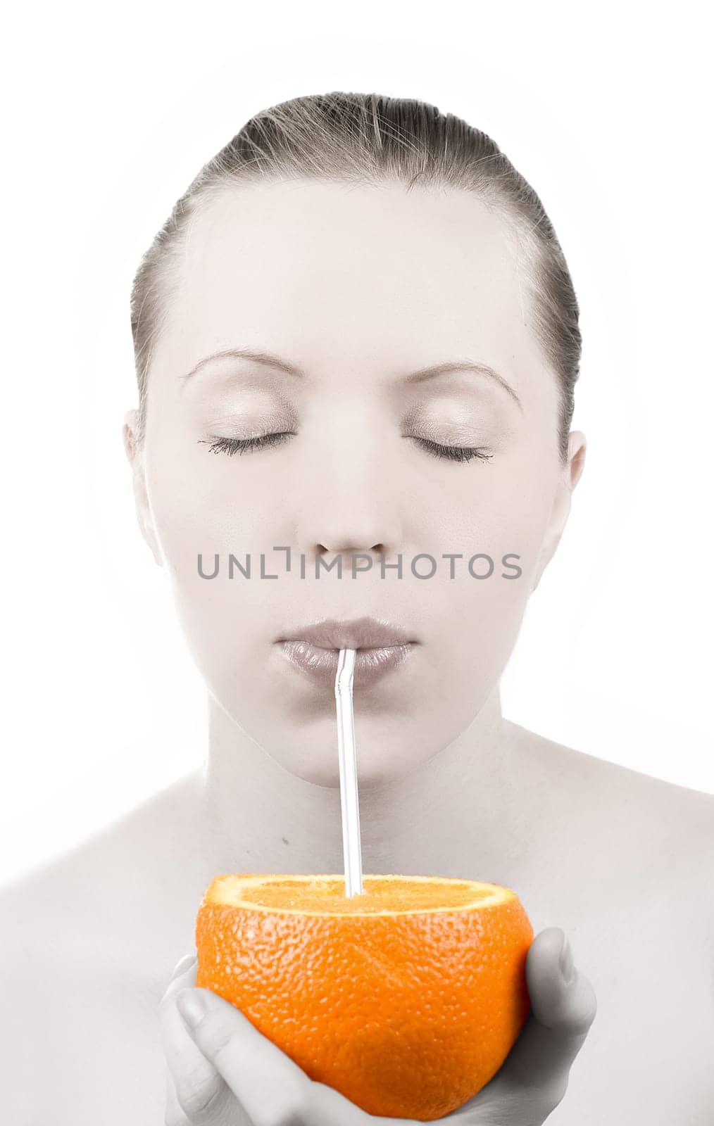 Pretty girl drink orange juice on white