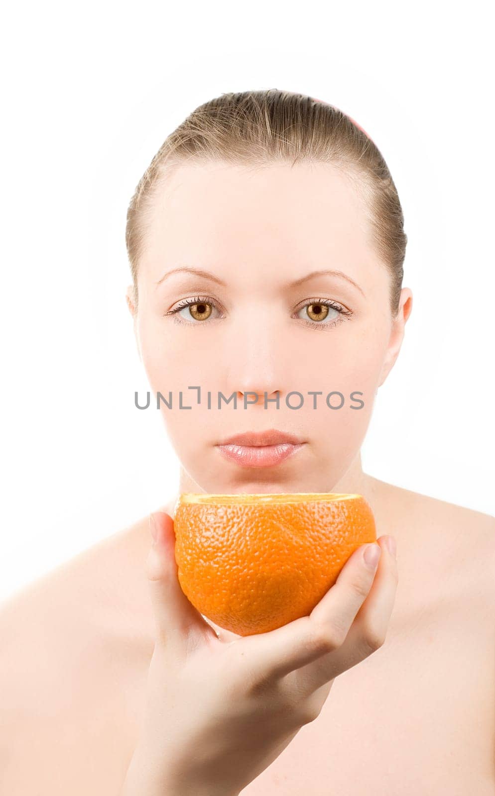 Pretty girl with orange fruit on white