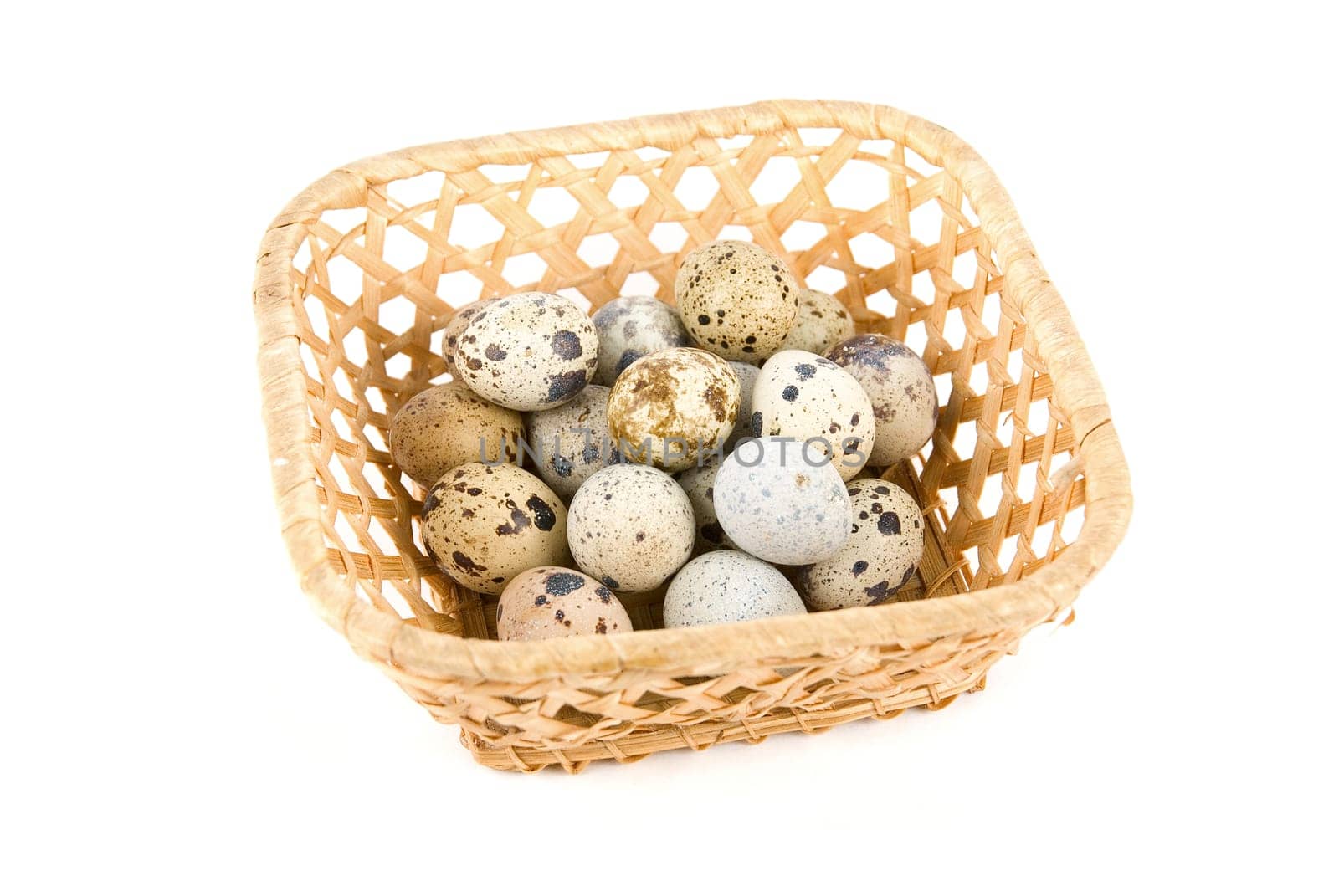 quail eggs in the basket on white