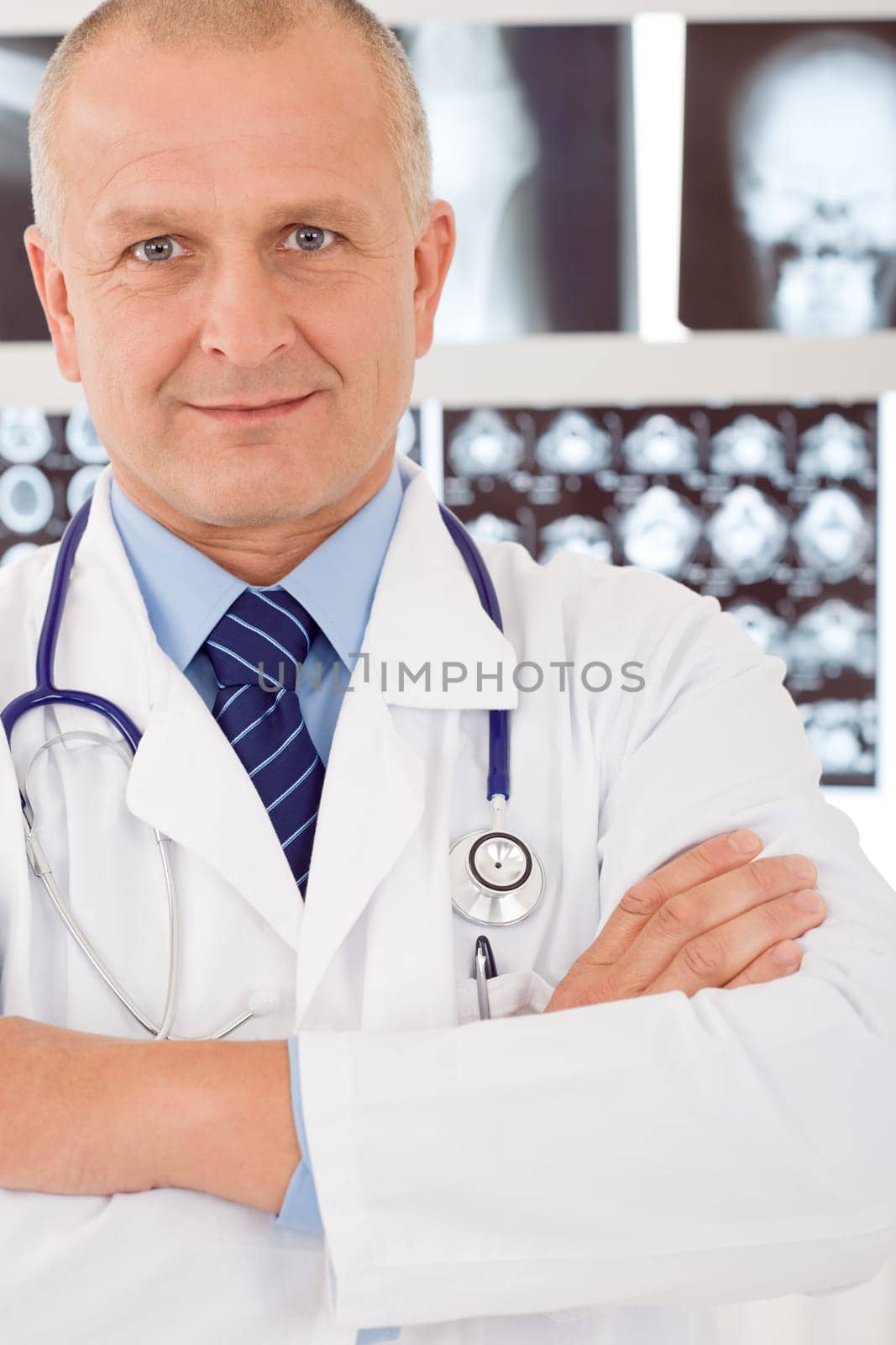 Portrait of male doctor standing at front of set x-ray