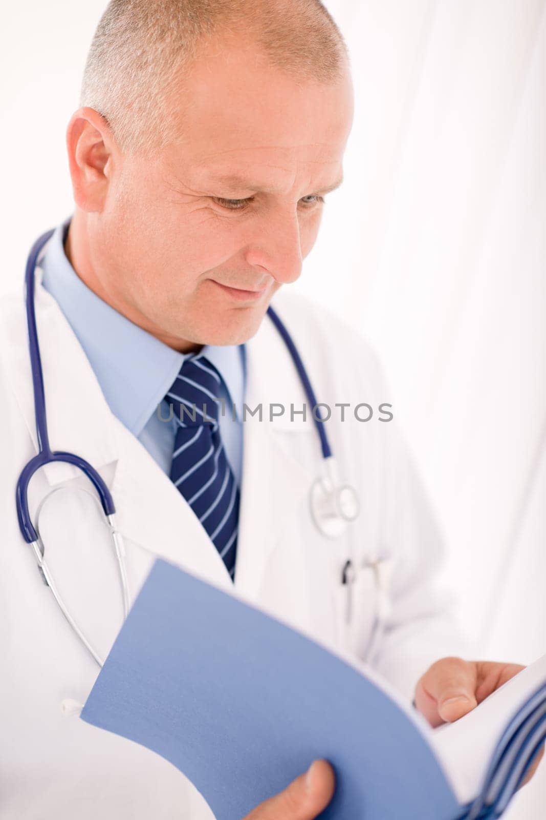 Professional senior doctor male with stethoscope look down document folders