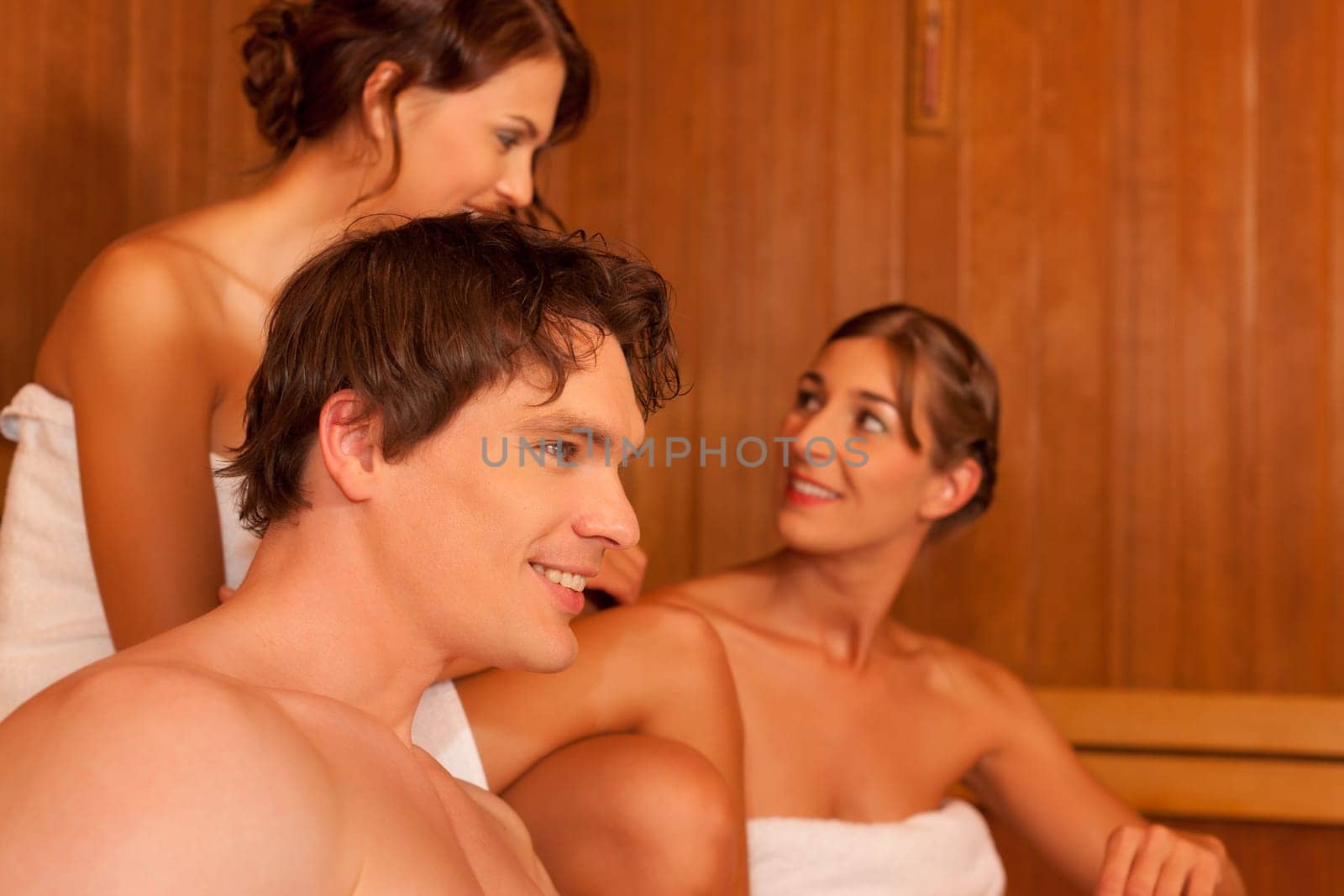 Three people or friends in the sauna