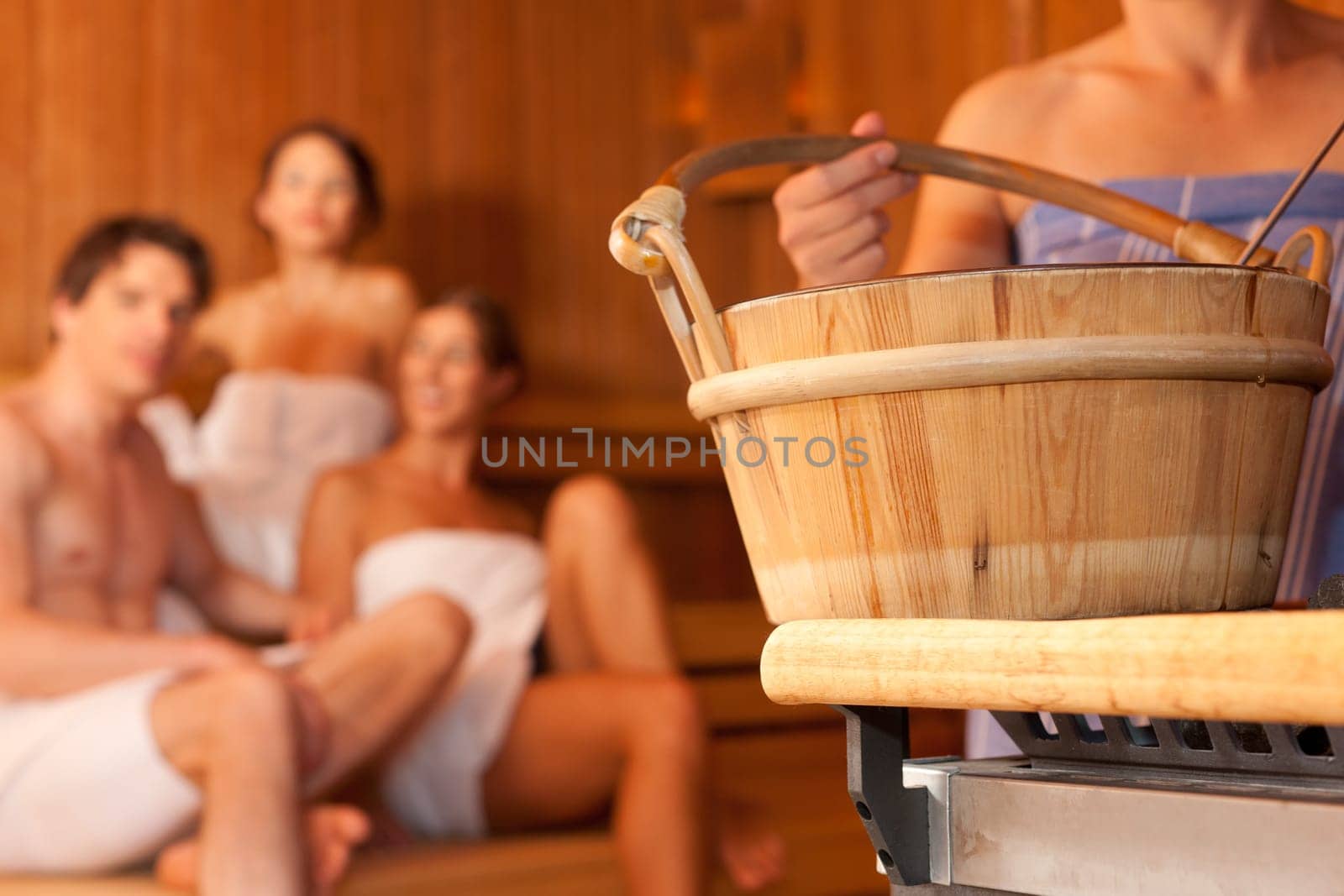 Four friends in the sauna of a thermal bath