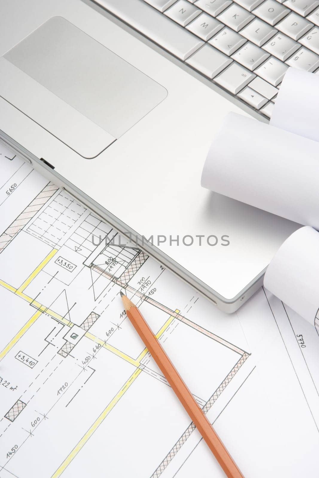 Architect workplace - architecture blueprints, pencil and laptop