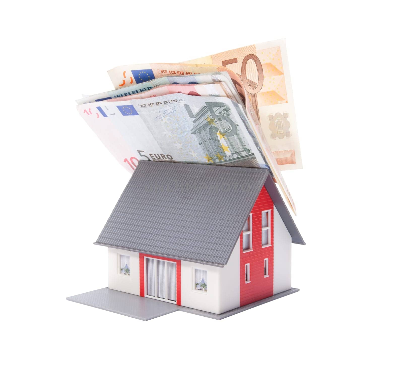 Housing finance, building savings and realty financing (investments) concept. Money on model of the family house roof.