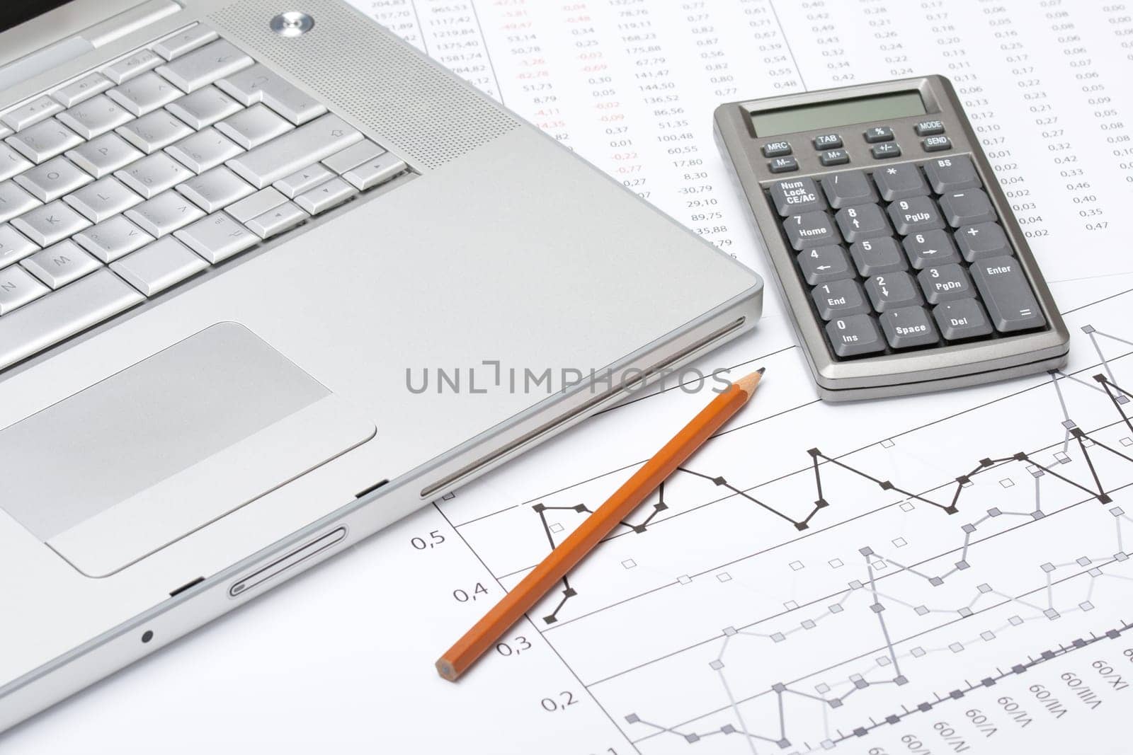 Business analyze with laptop, calculator and printed data sheet