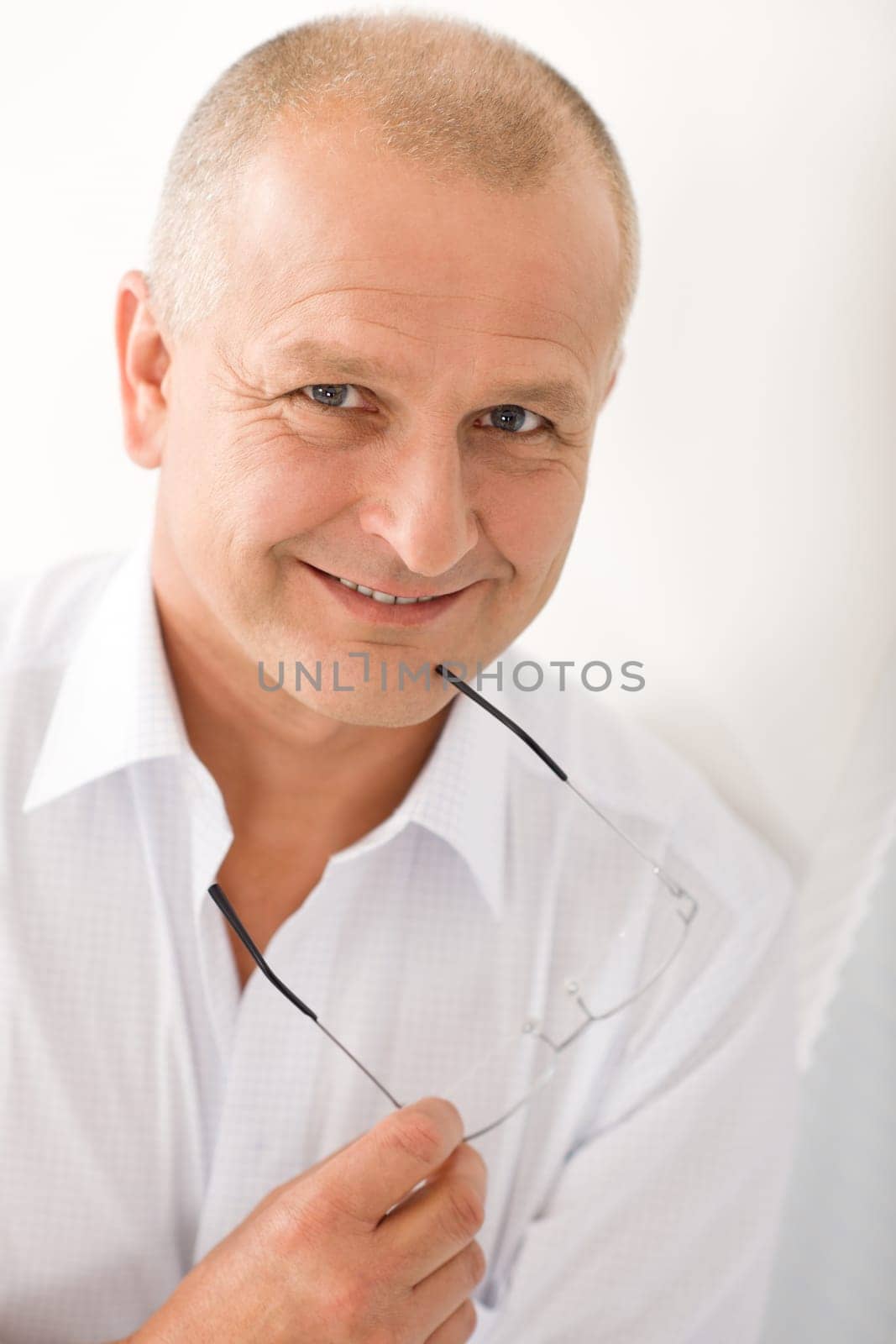 Happy successful mature businessman professional portrait smiling hold glasses