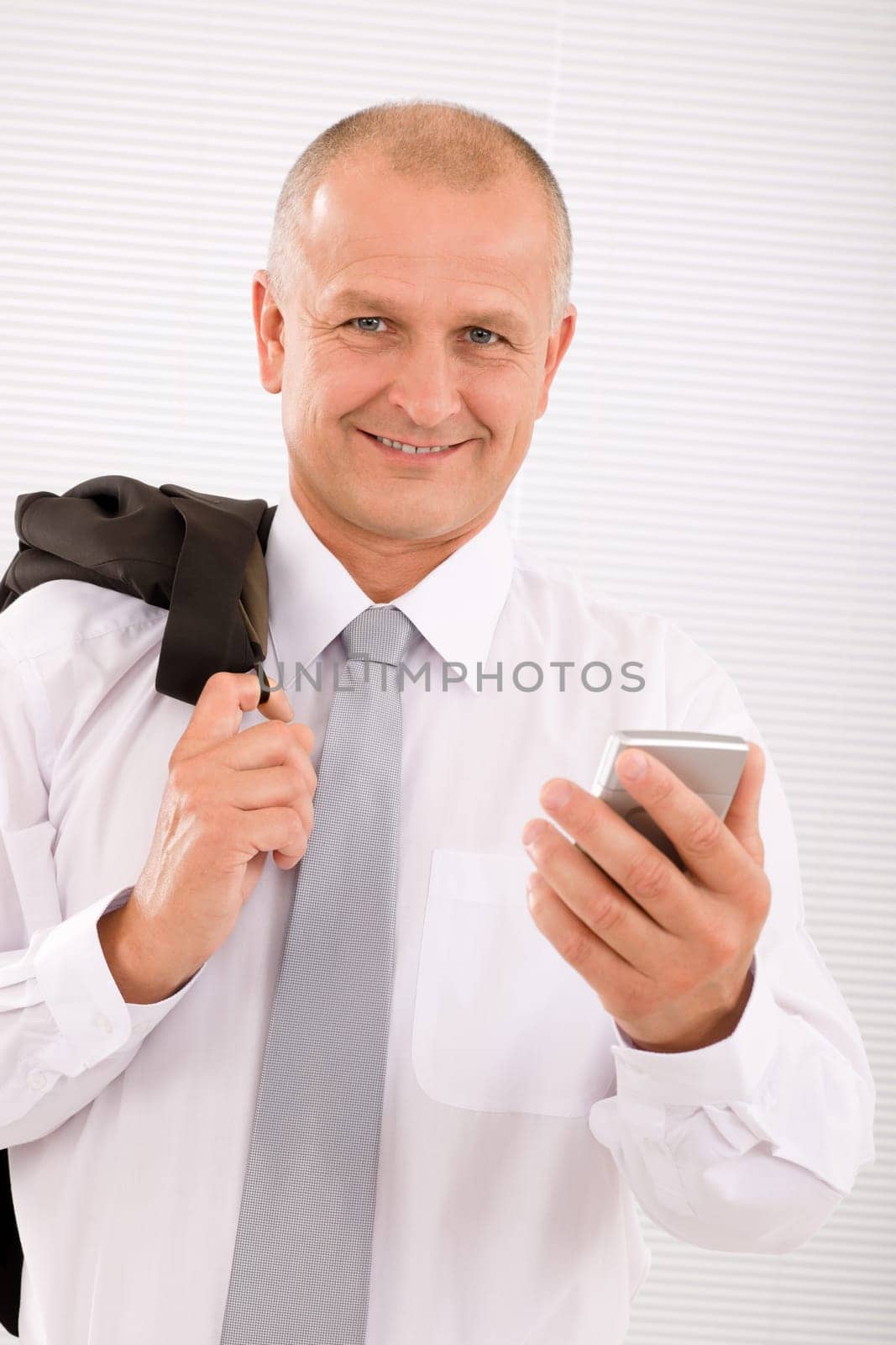 Mature handsome businessman wear suit with phone jacket over shoulder