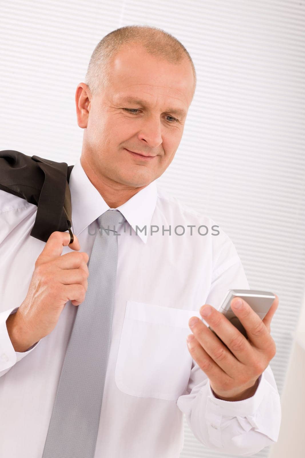Mature handsome businessman wear suit looking at phone close-up portrait