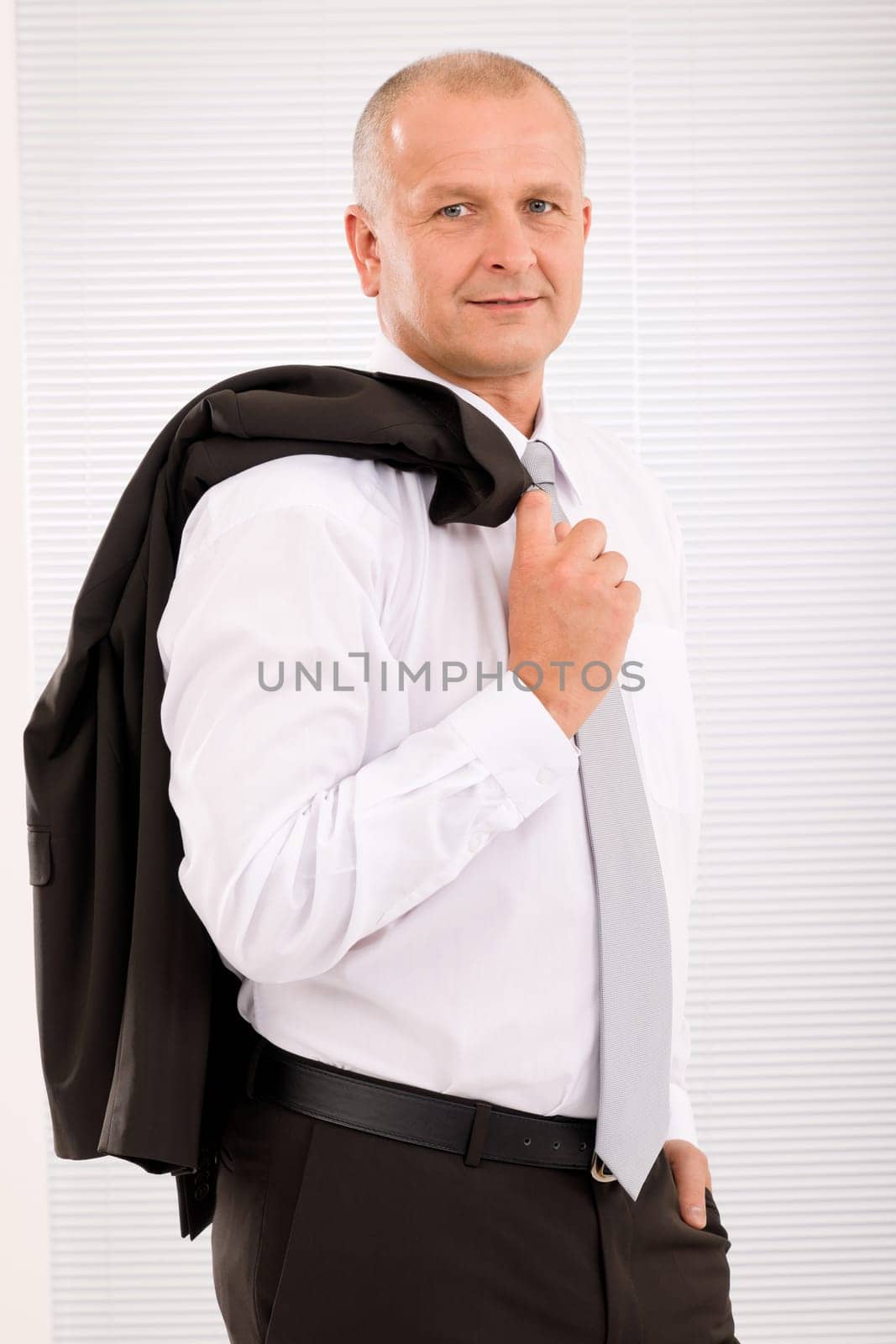 Successful mature businessman professional portrait jacket over shoulder