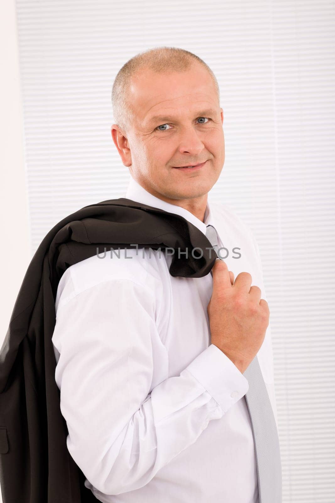 Successful mature businessman professional portrait jacket over shoulder