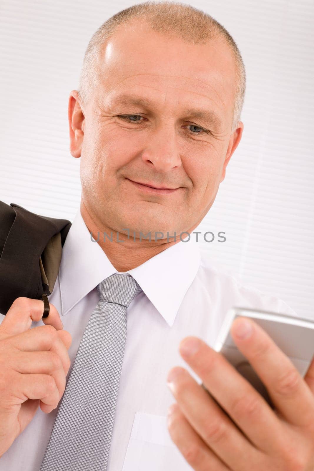 Mature handsome businessman wear suit looking at phone close-up portrait