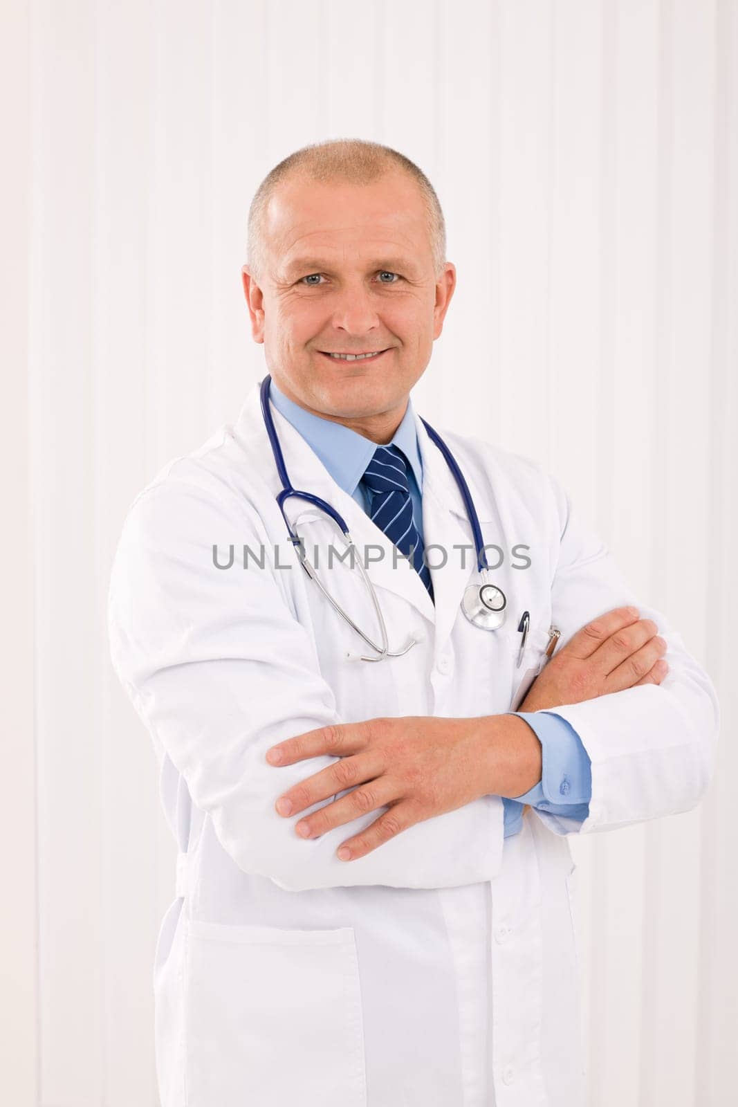 Portrait of mature professional doctor male with stethoscope crossed arms