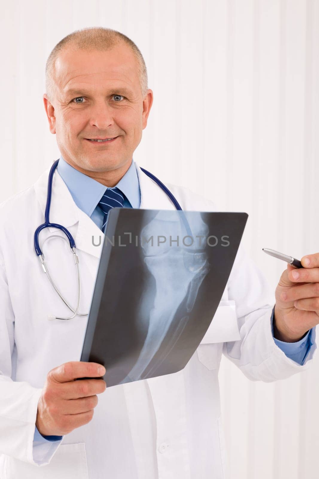Portrait of professional male doctor hold and point x-ray