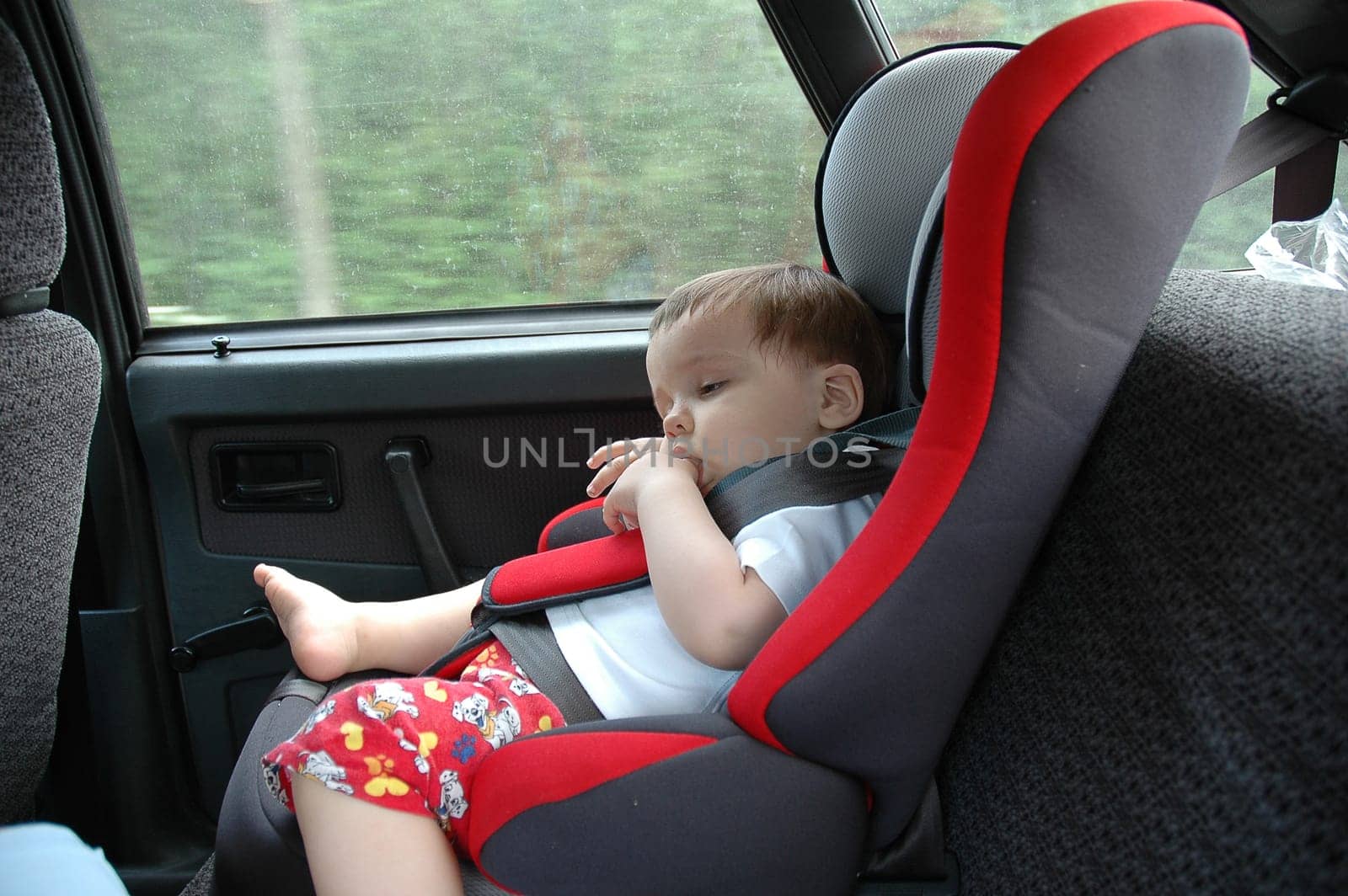 sweet child in car chair for safety journey