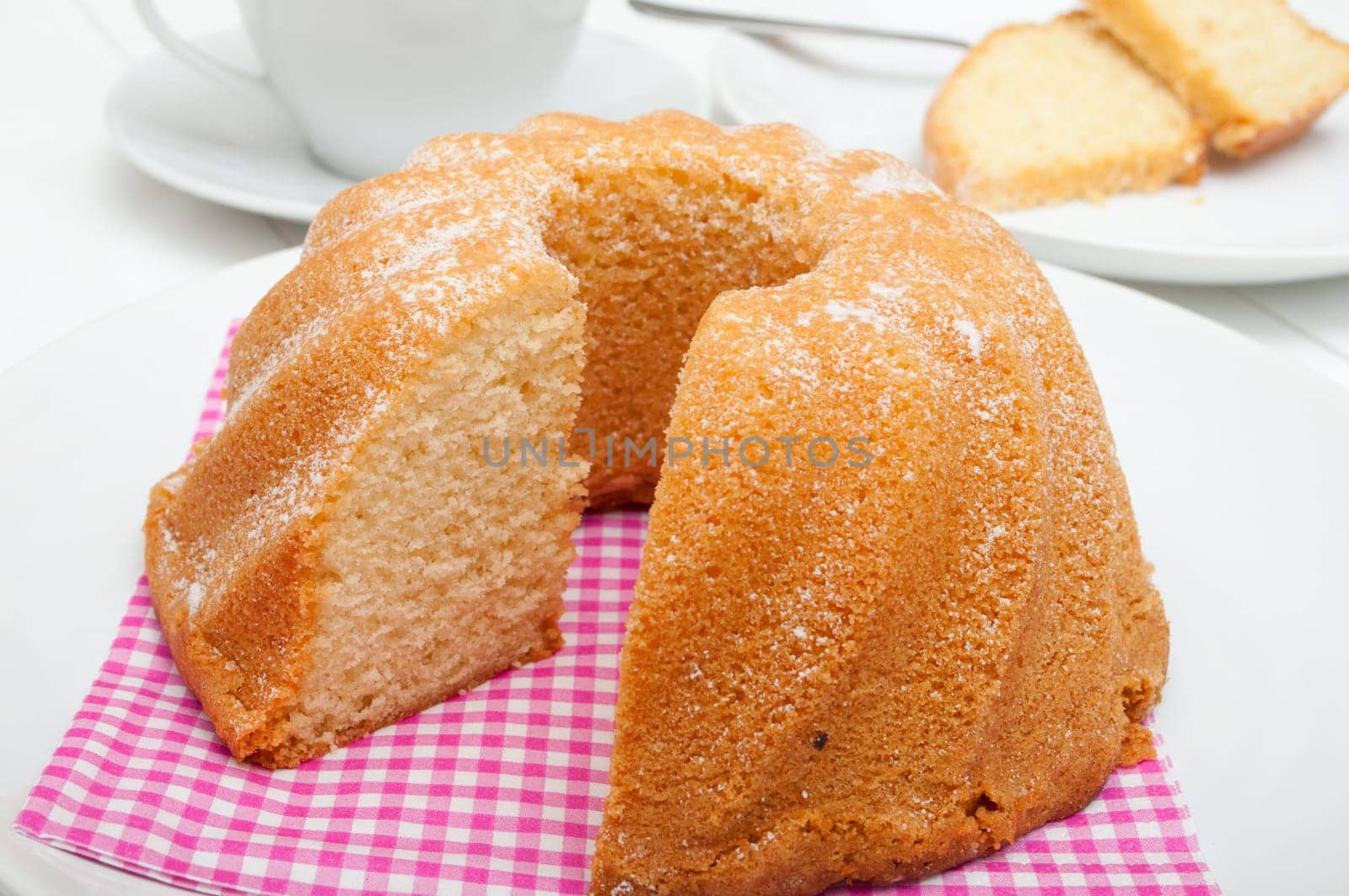 Guglhupf - Traditional Sponge Cake on Plate and Cup on Table