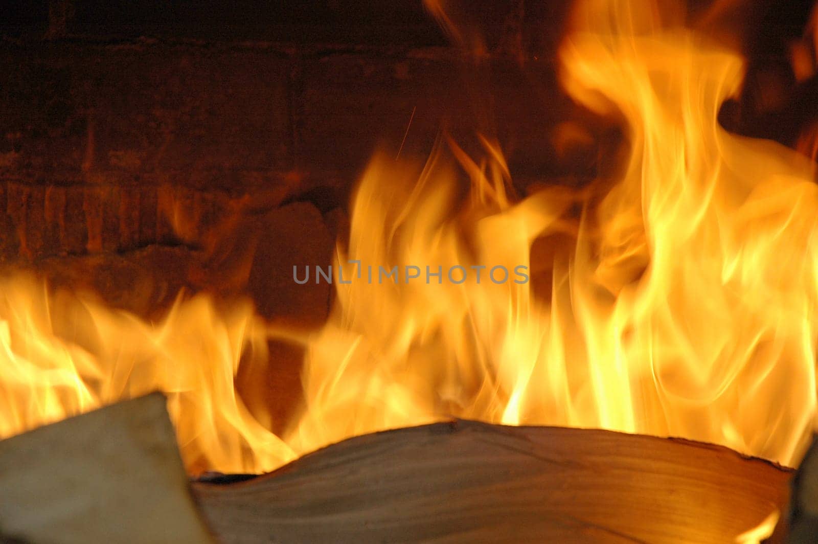 Hot fireplace full of fire wood and fire