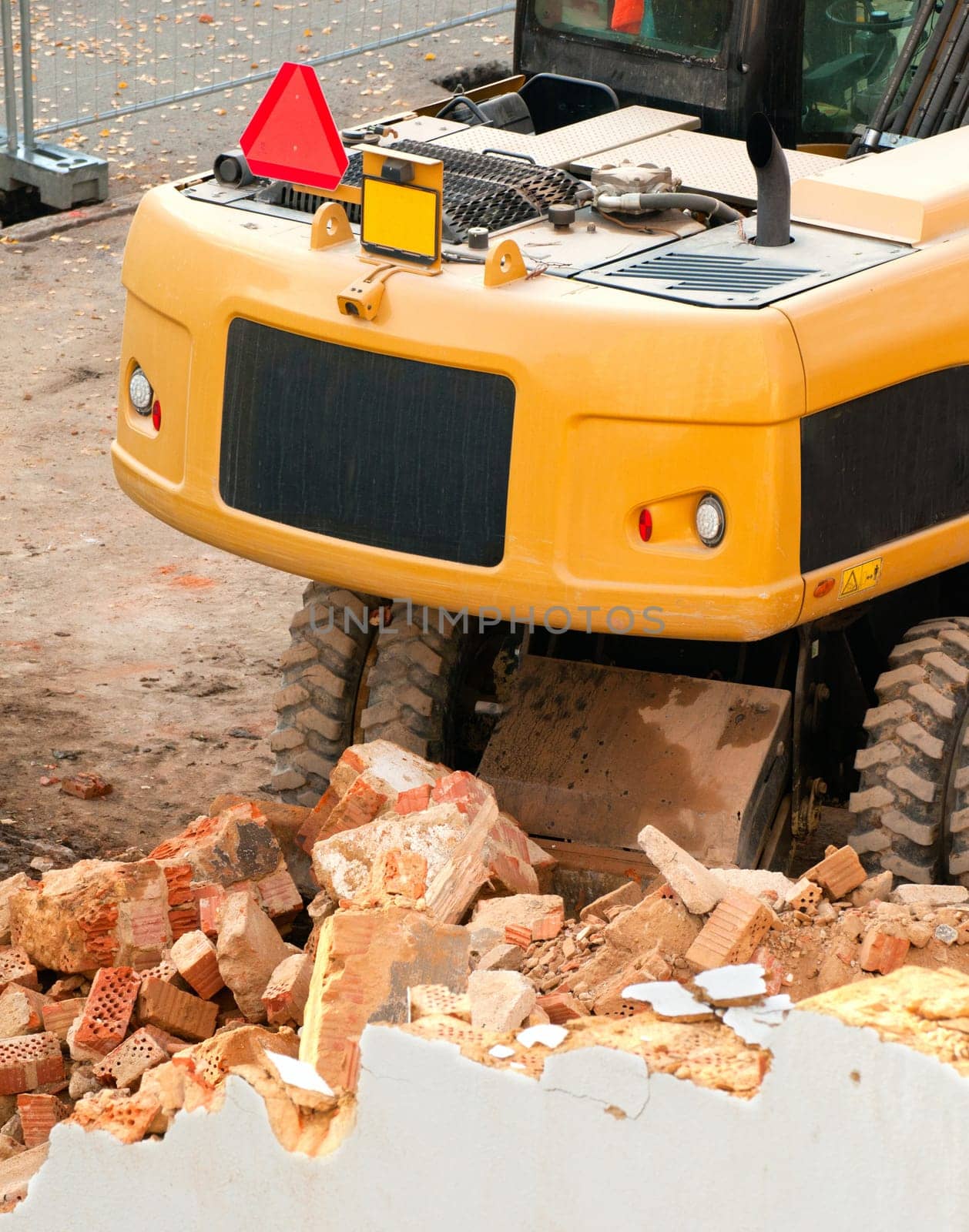 Detail of Yellow Digger Near Building Under Demolition