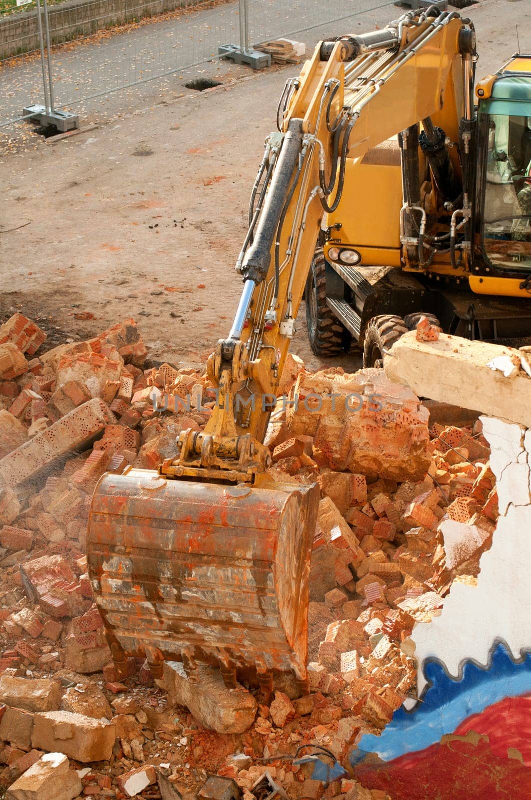 Yellow Digger in House Under Demolition