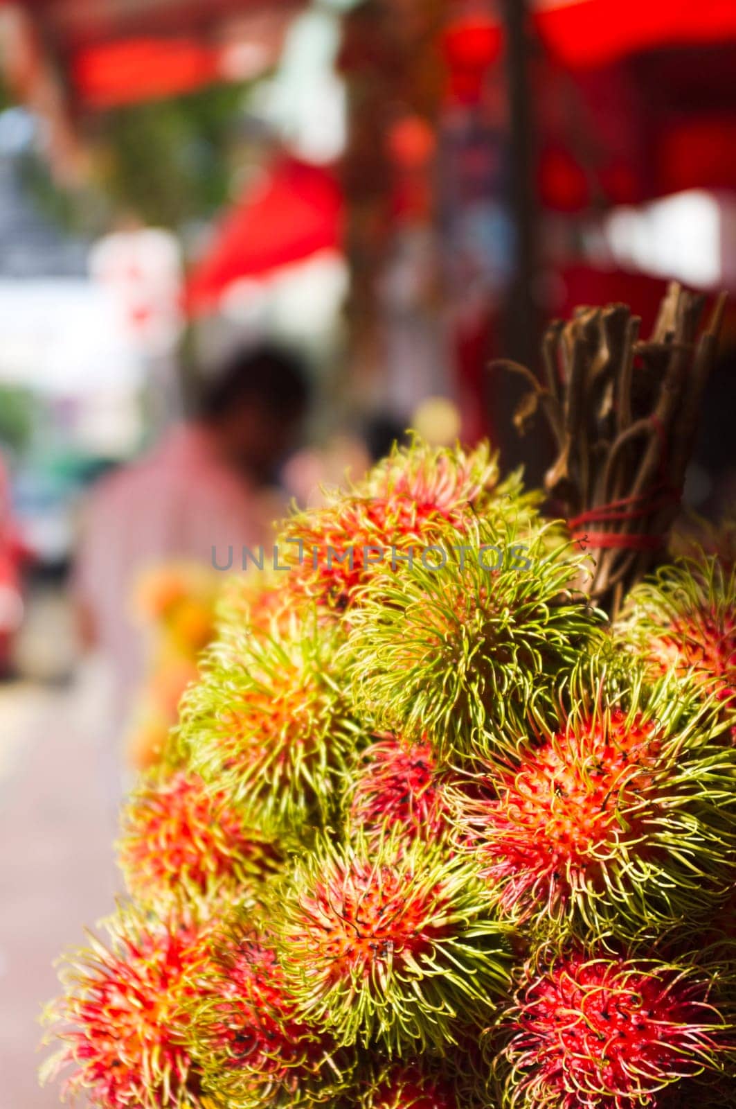rambutan fruits on sale in asia street, exotic tropical fruit.