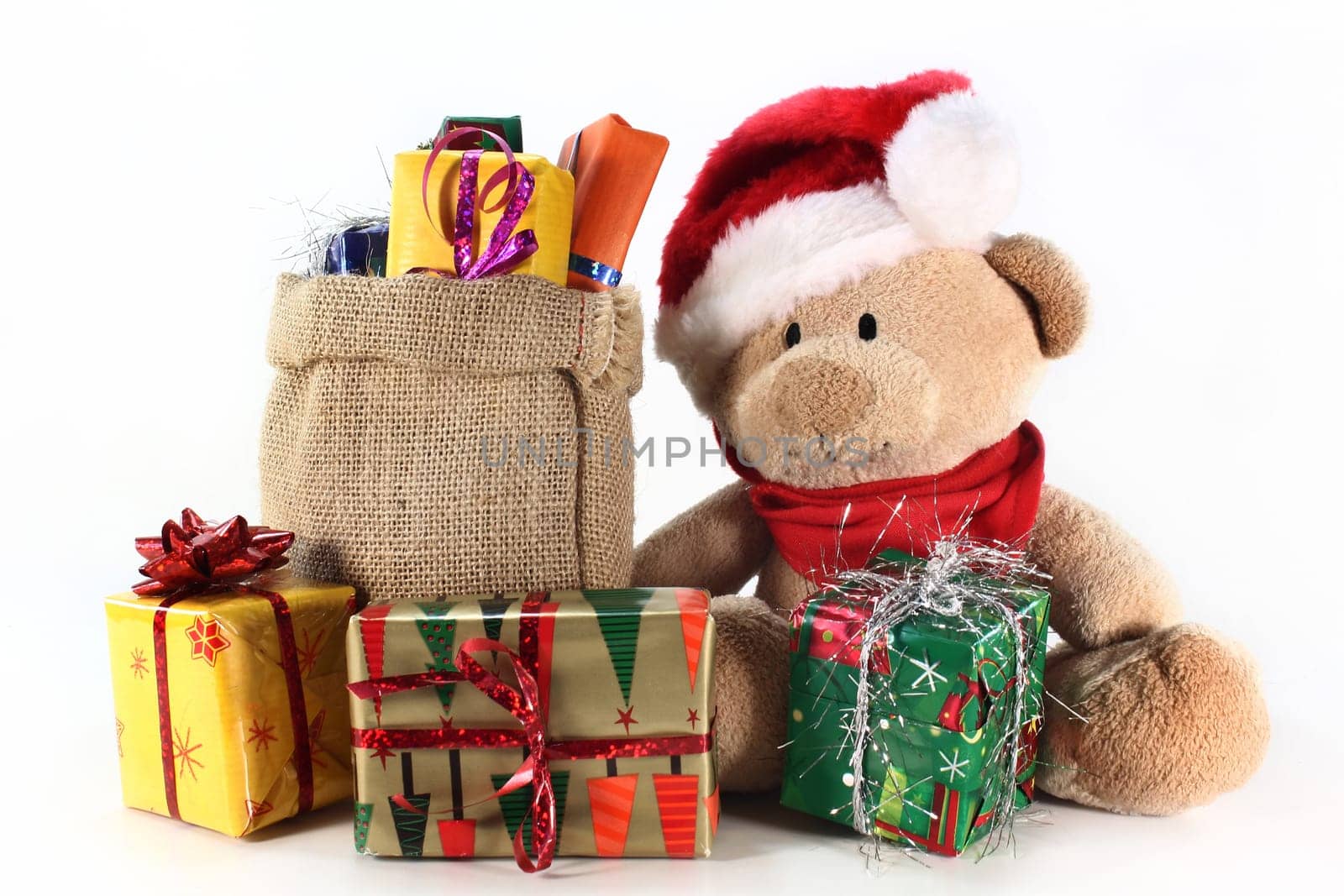 a teddy bear with many colorful Christmas gifts