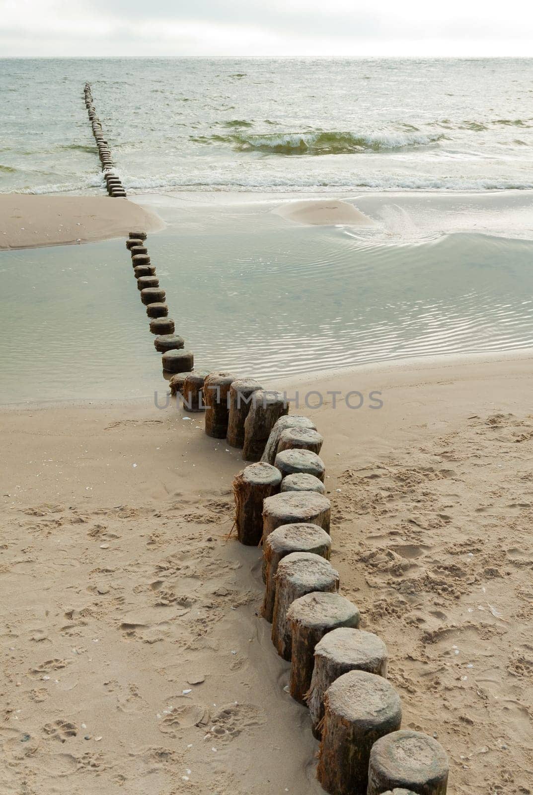 A groyne with Knich juts out into the Baltic Sea