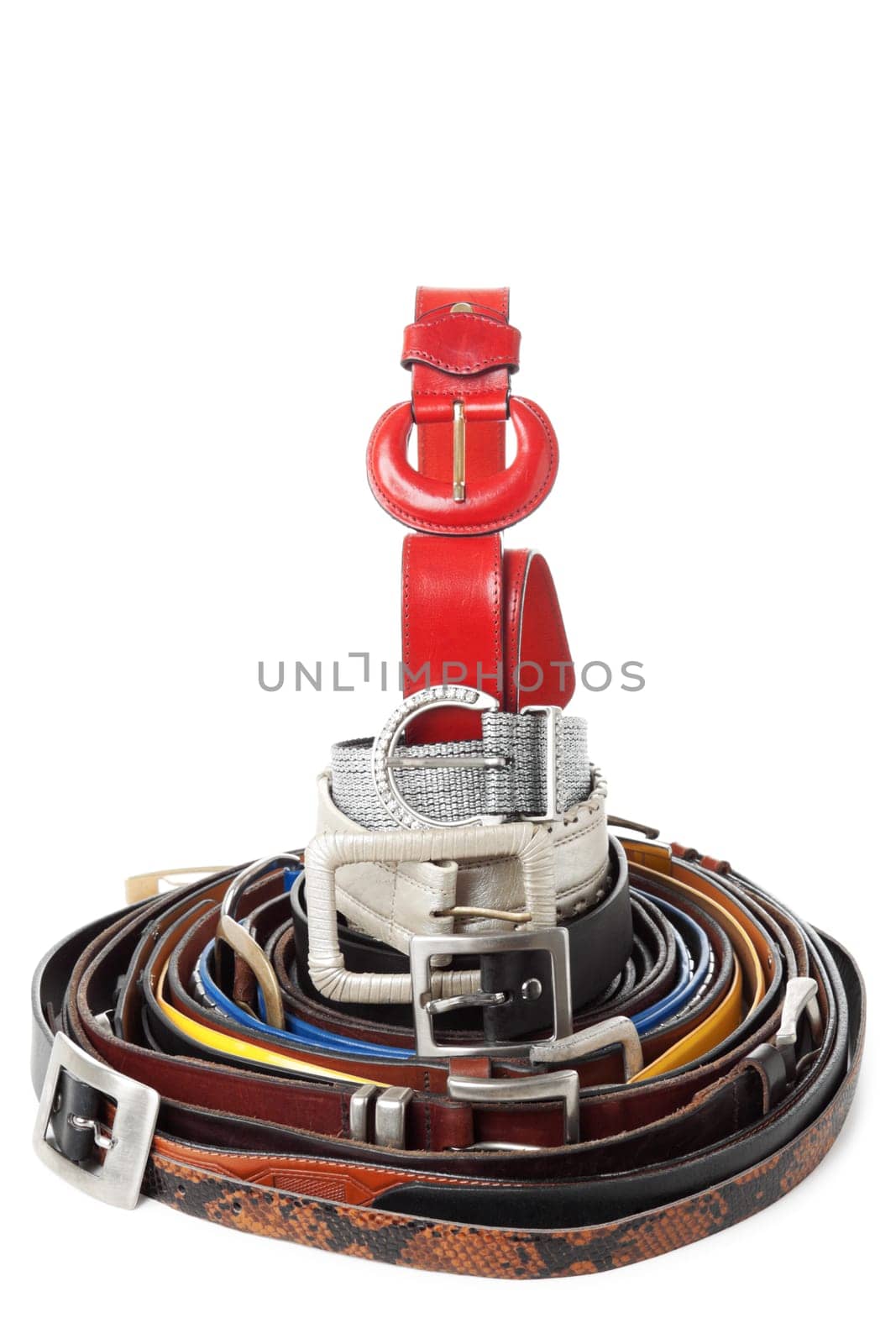 Large group of leather belts isolated over white background. Belts organased in big rolled form