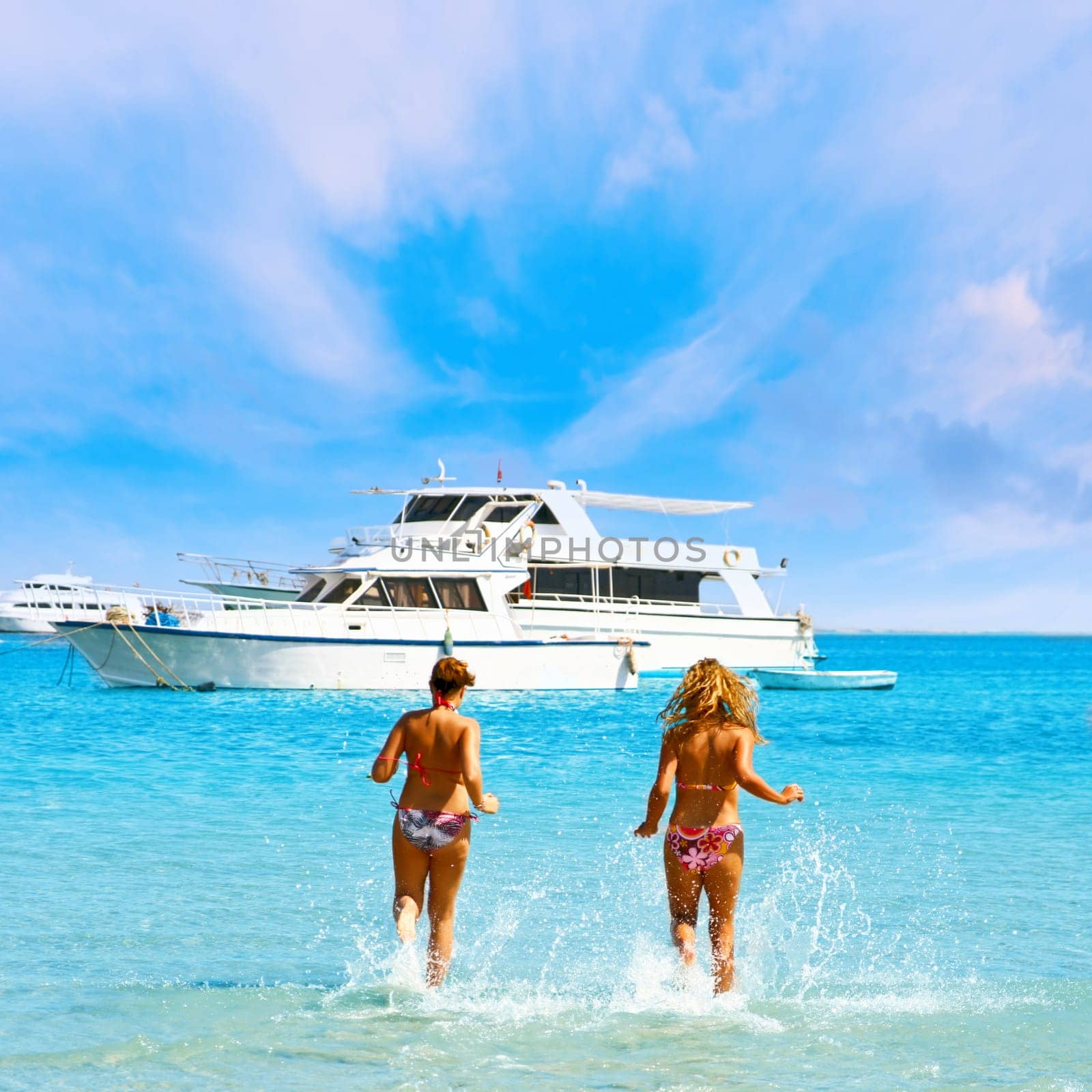 Two attractive girls enjoying the sea