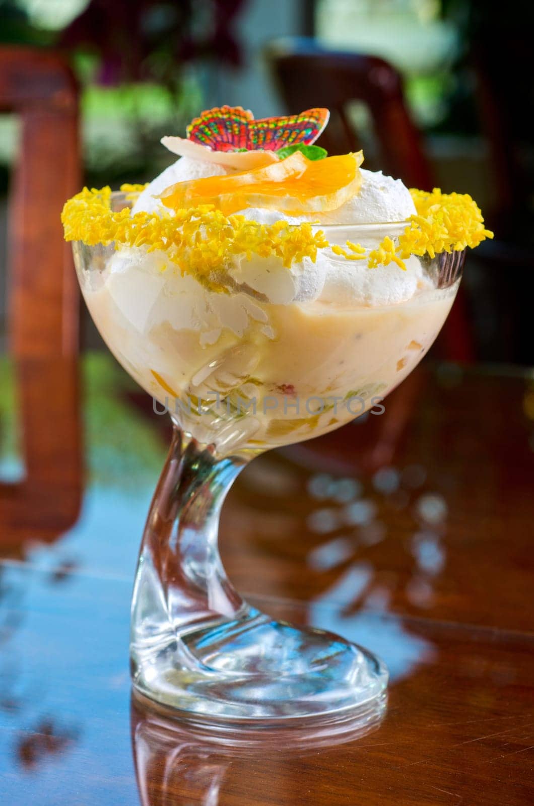 Ice cream dessert with kiwi and orange decorated with butterfly