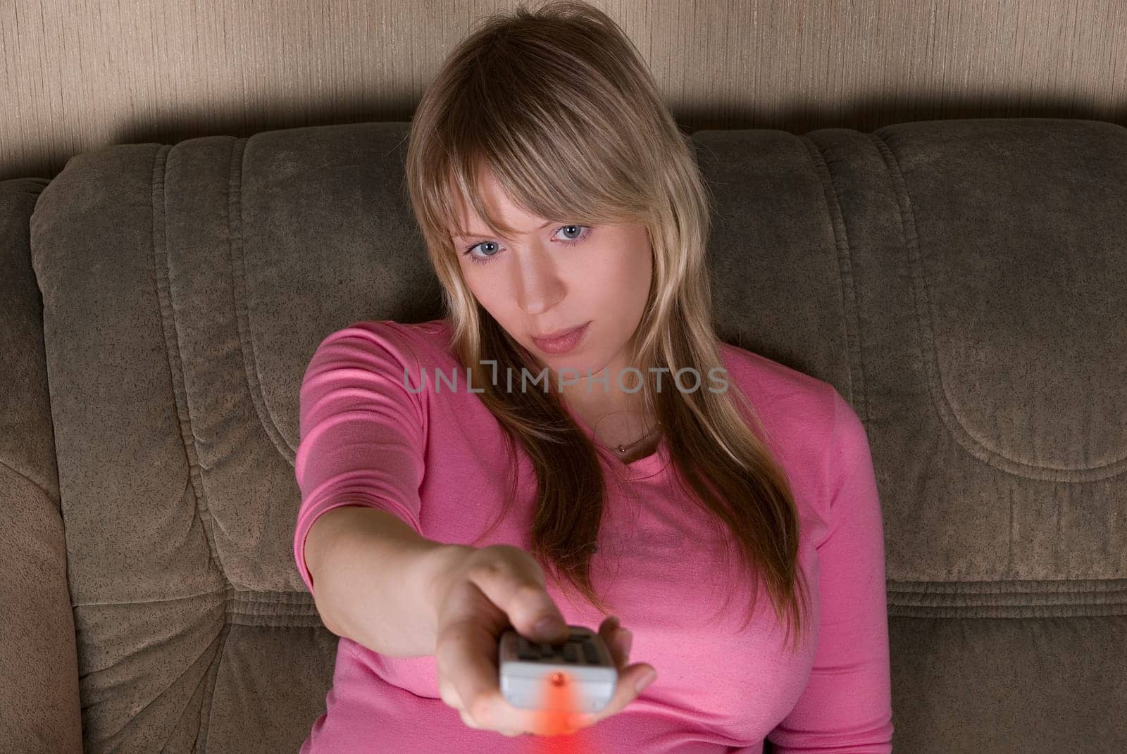 Woman sitting on the sofa and watching tv