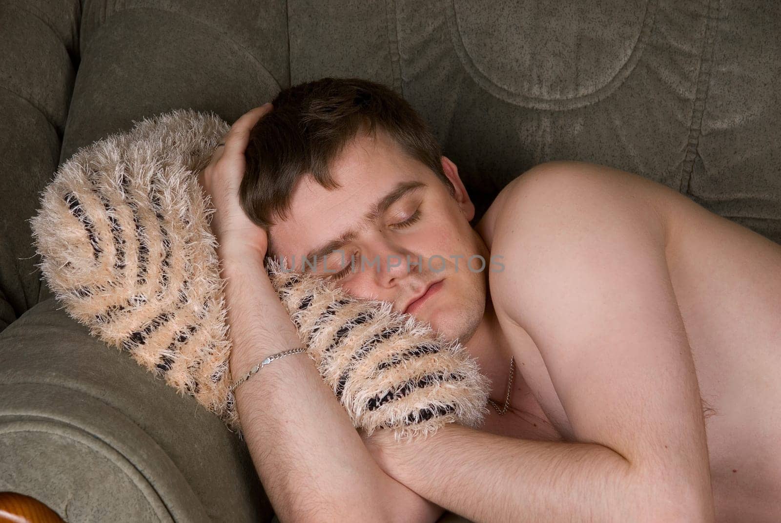 A man sleeps on the sofa