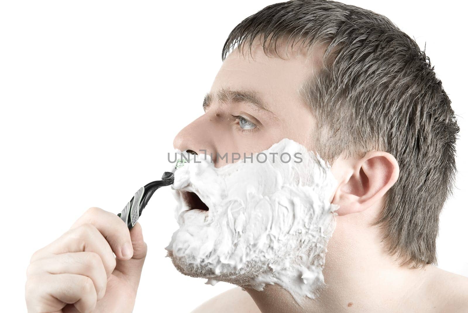 Man shaving razor with foam on white