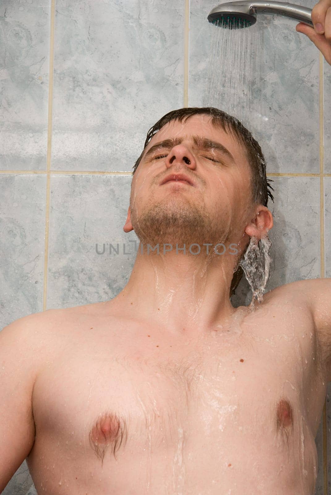 Man having shower in bathroom